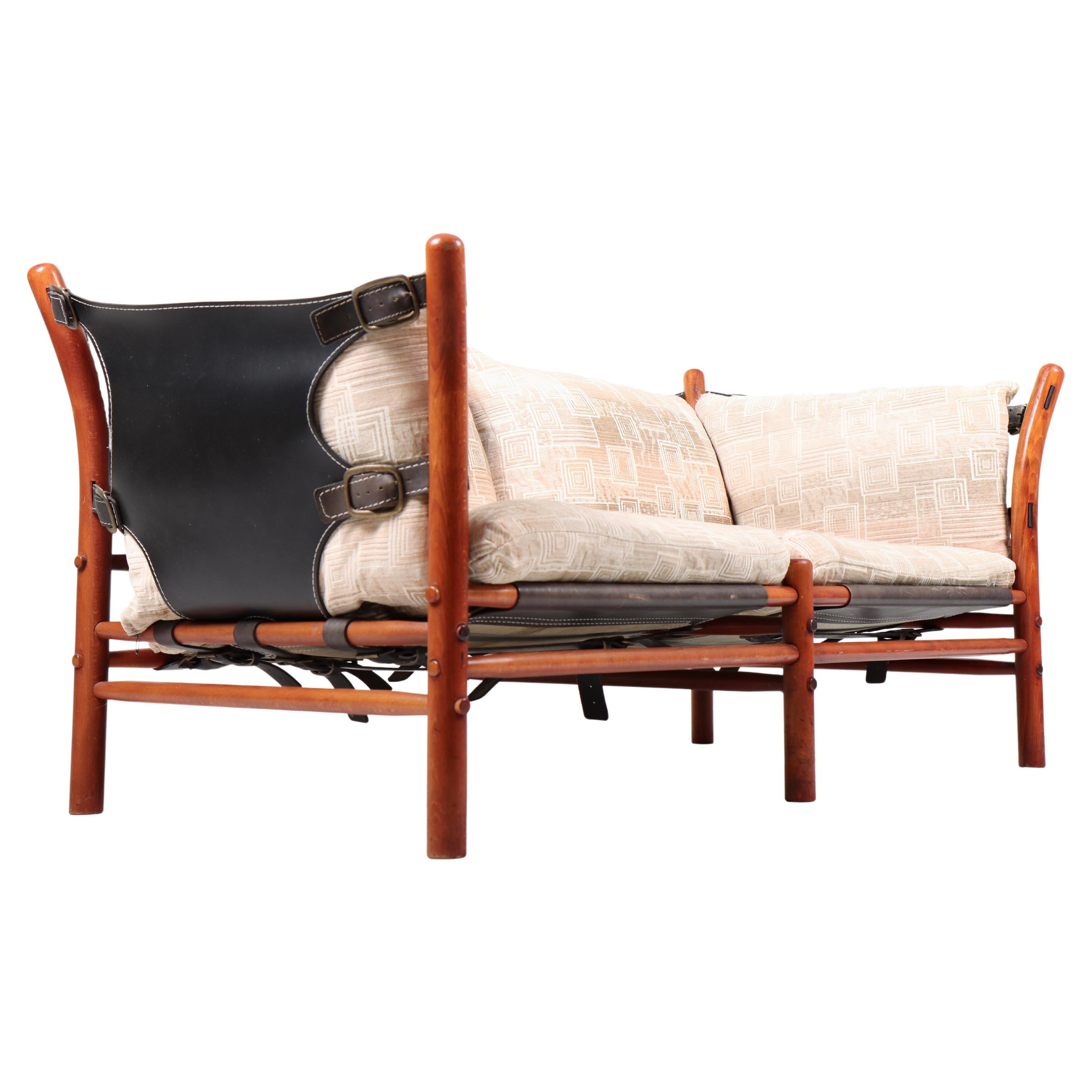 Two-seat sofa with fabric cushions, leather, wood frame and brass hardware. Model Ilona designed by Swedish architect Arne Norell for Norell Möbel AB in the 1960s. 

 