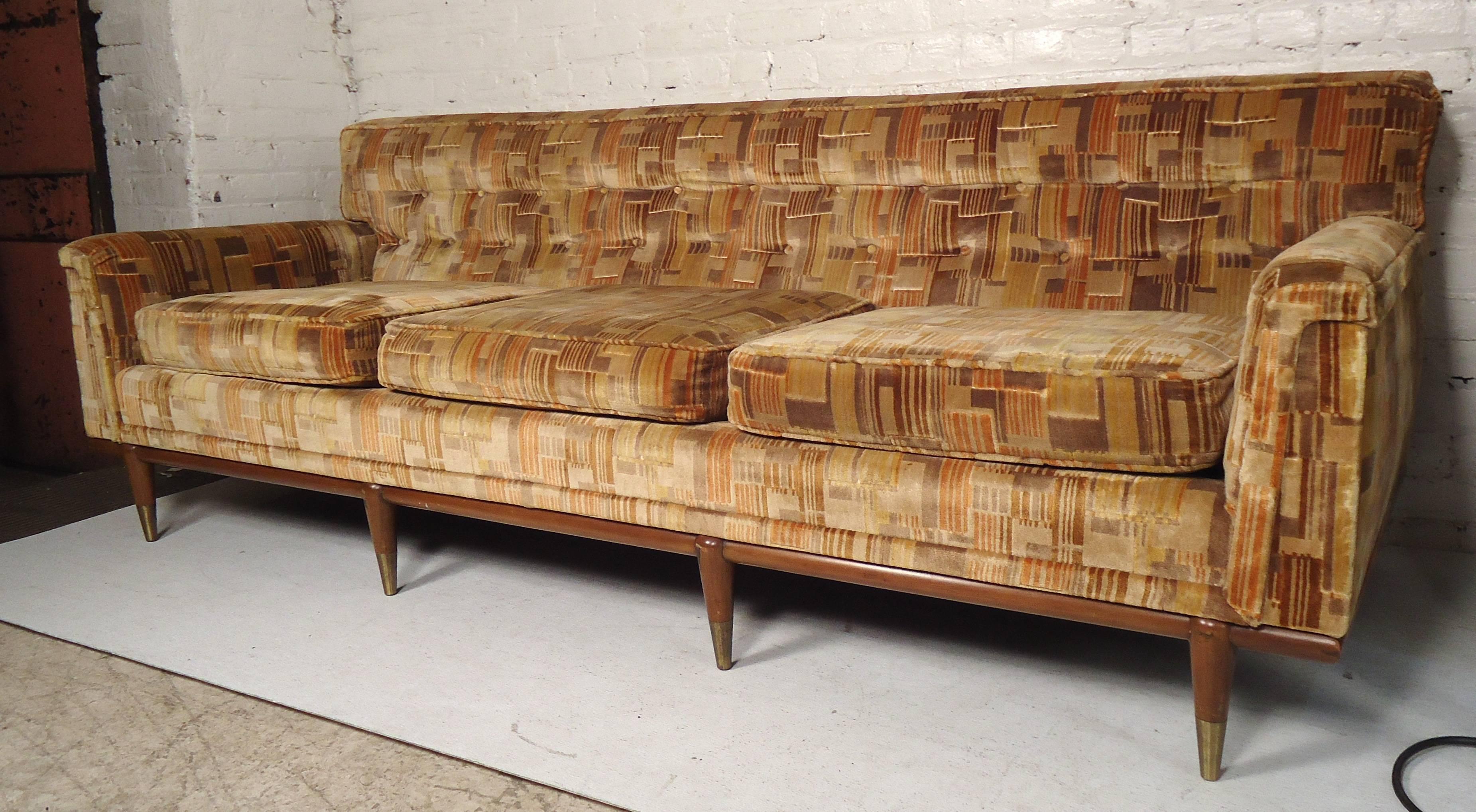 Long sofa with walnut legs and trim by John Widdicomb. Attractive brass foot caps and tufted back.

(Please confirm item location NY or NJ with dealer).
 