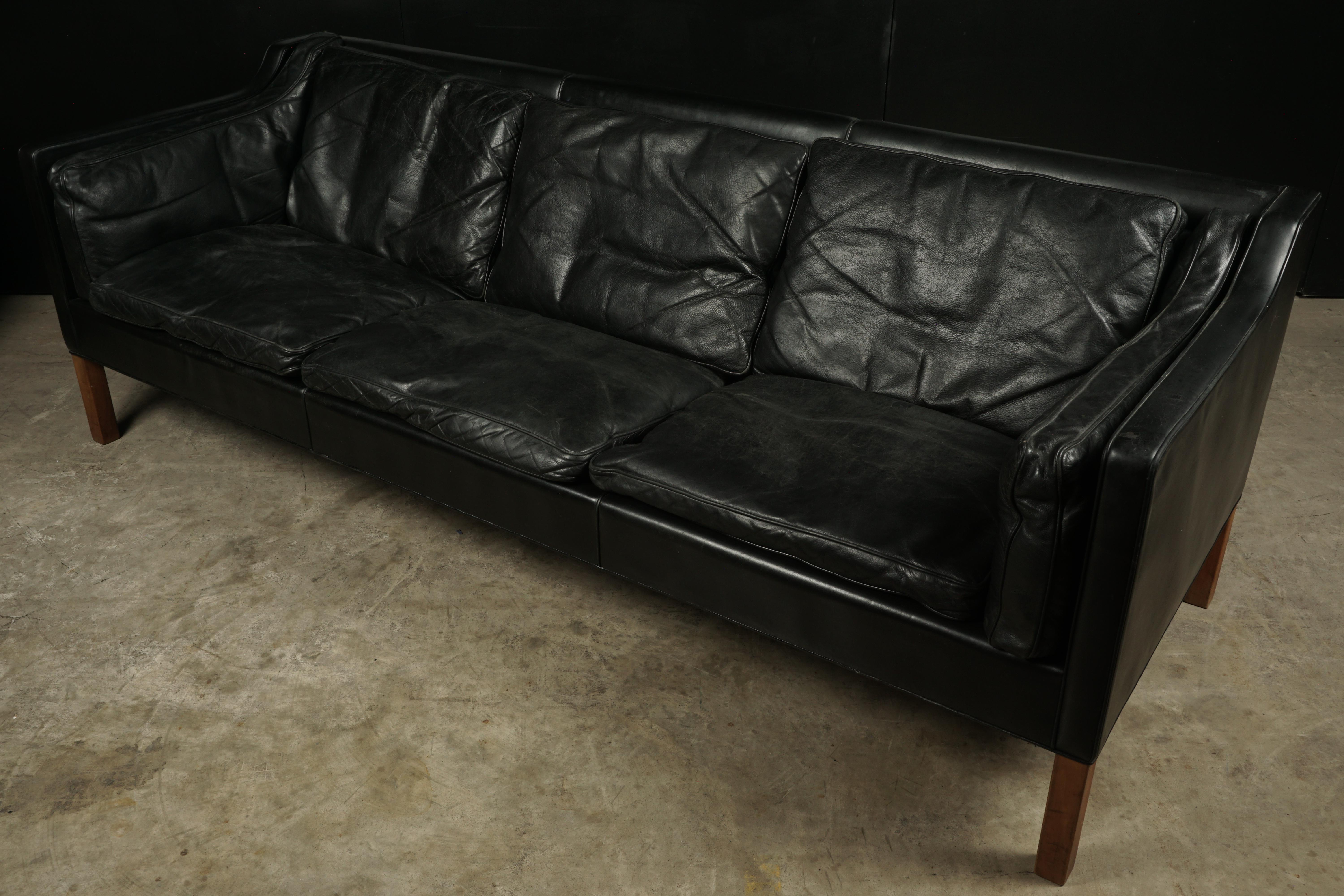 Midcentury sofa designed by Børge Mogensen, model 2213. Original black leather upholstery, with down filled cushions. Nice wear and patina.
