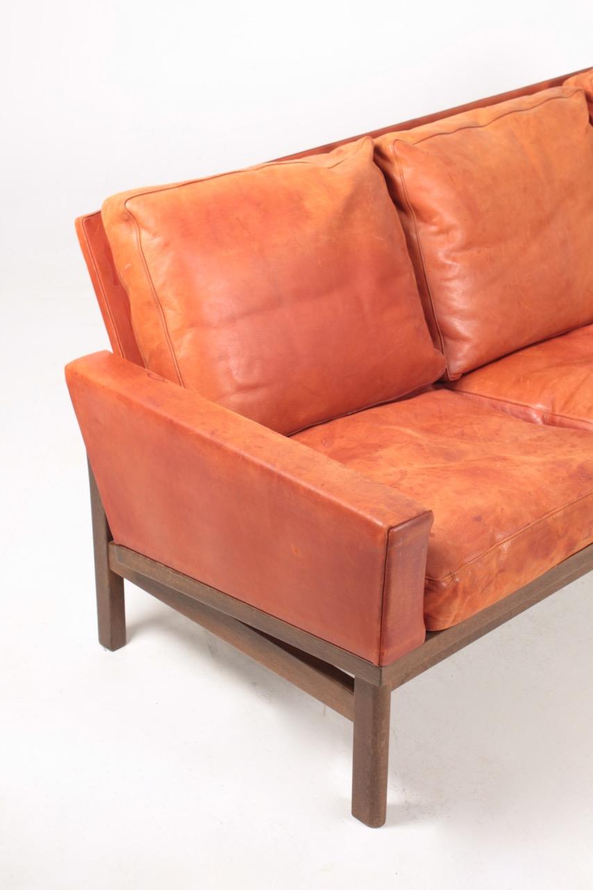 Three-seat sofa in patinated leather designed by Poul Volther for Erik Jørgensen in the 1960s. Made in Denmark. Good original condition.