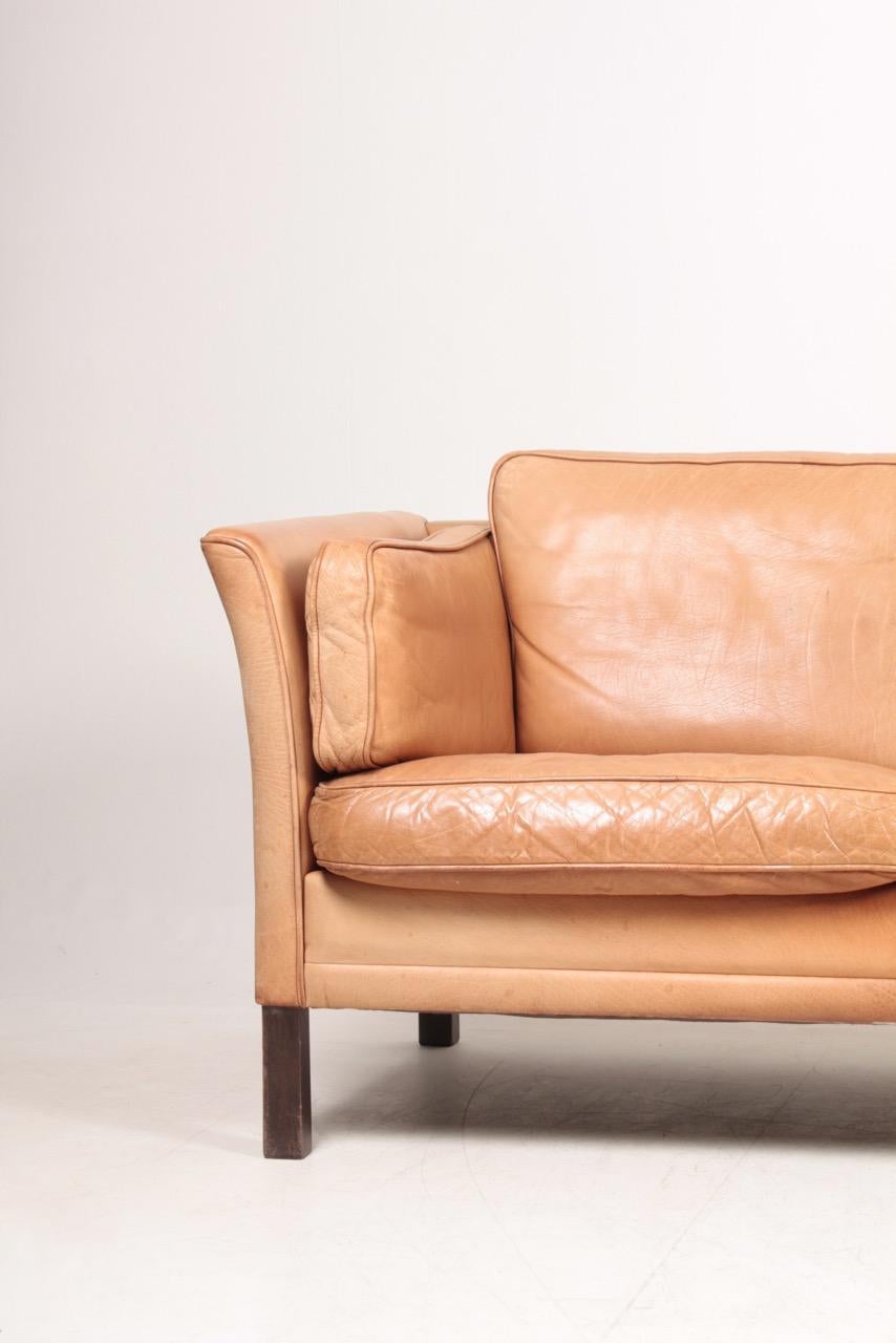 Three-seat sofa in patinated leather designed by Mogens Hansen in the 1980s. Great original condition. Made in Denmark.