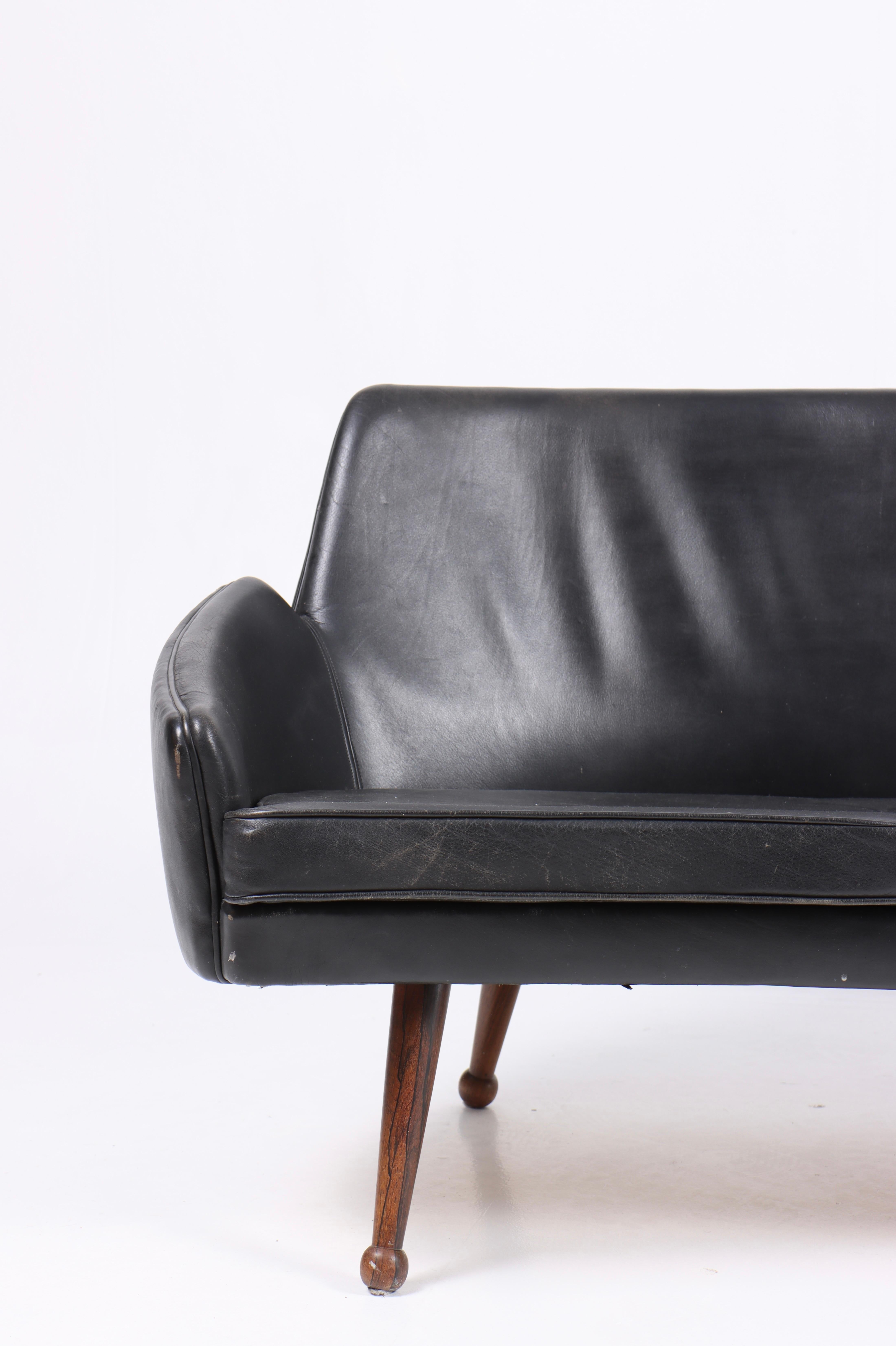 Leicht geschwungenes, dreisitziges Sofa aus patiniertem Leder, entworfen und hergestellt in Dänemark. Toller Originalzustand.