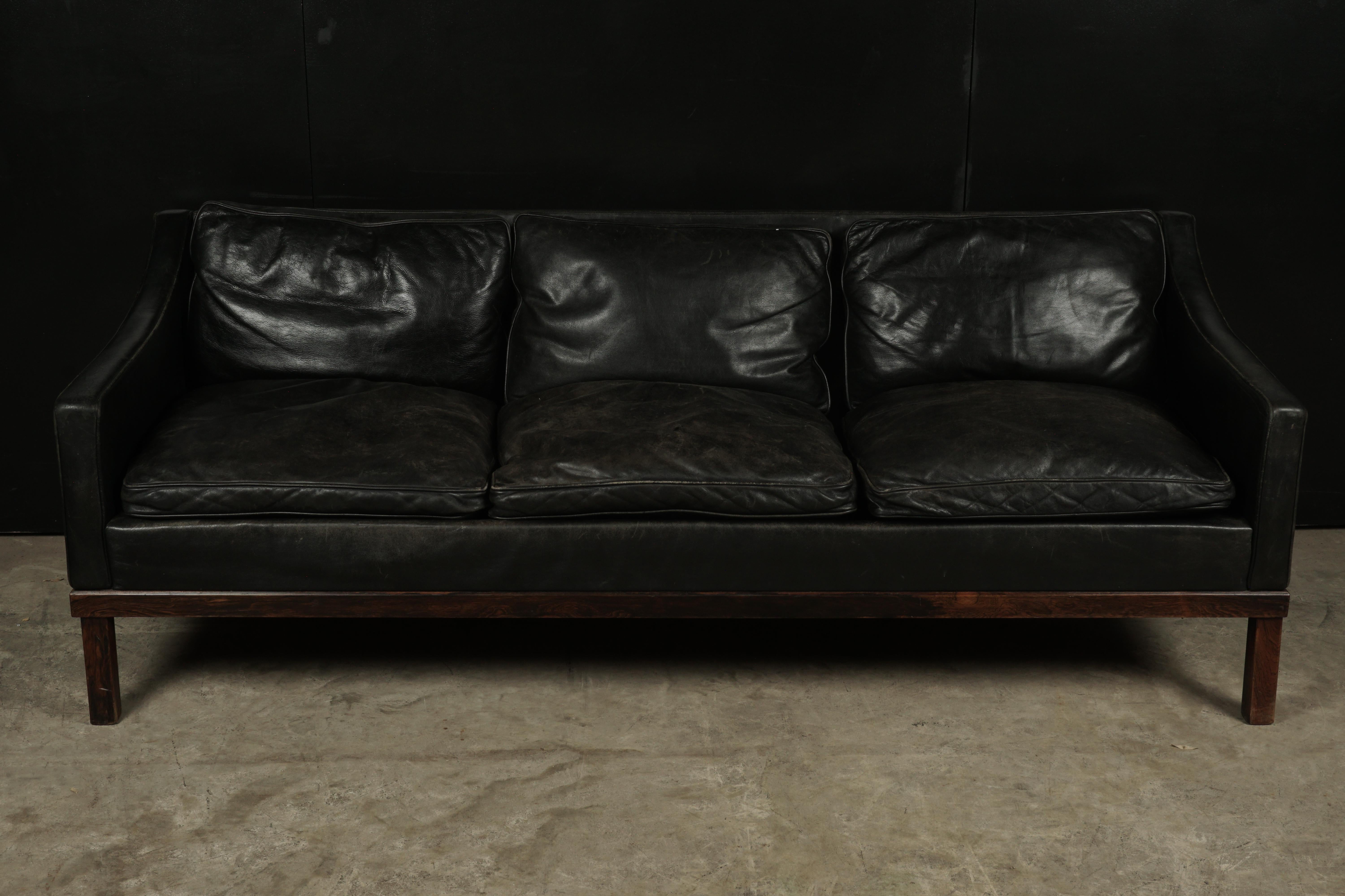 Midcentury sofa manufactured by OPE, Sweden, circa 1970. Original black leather upholstery with great patina.