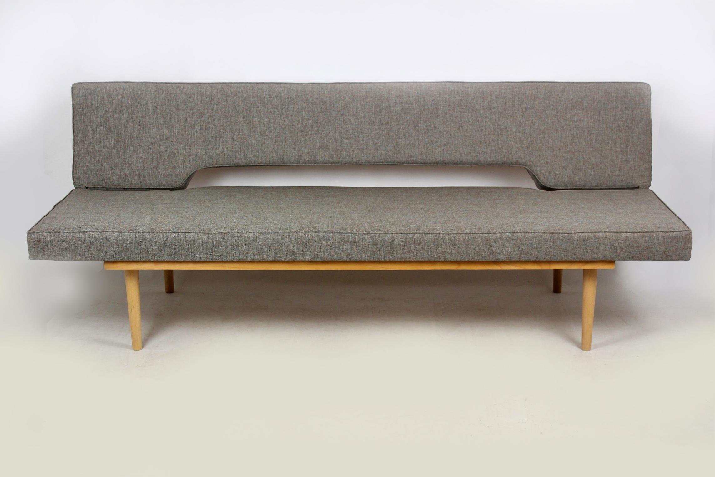 Midcentury sofa in a simple, minimalistic form, designed by Miroslav Navratil in the 1960s-1970s. The couch simply converts into a daybed (195 x 85cm). Completely restored – woodwork has been refinished in satin, pillows have been upholstered with