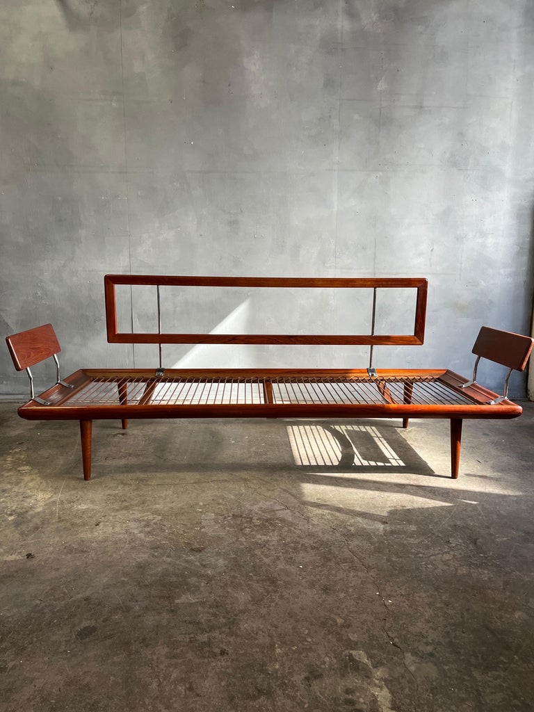 Iconic mid century sofa or daybed in teakwood with chromed details. All hardware and springs are present. Cushions are available as a template but should be recovered. A day bed or sofa by Peter Hvidt & Orla Mølgaard-Nielsen France & Søn. A john