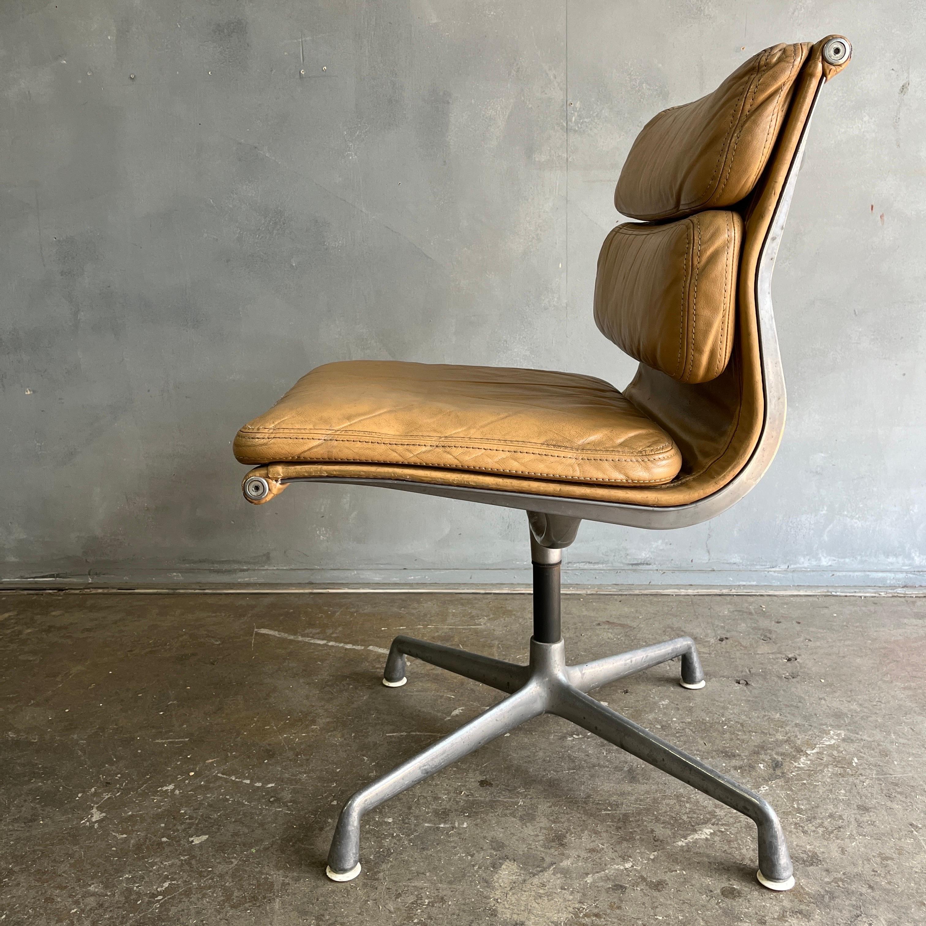 For your consideration is this authentic Eames for Herman Miller vintage soft pad chair in brown/ tan leather. Swivel and fixed height. This authentic vintage example is an icon of Mid-Century Modern design. Part of the Eames Aluminum Group that