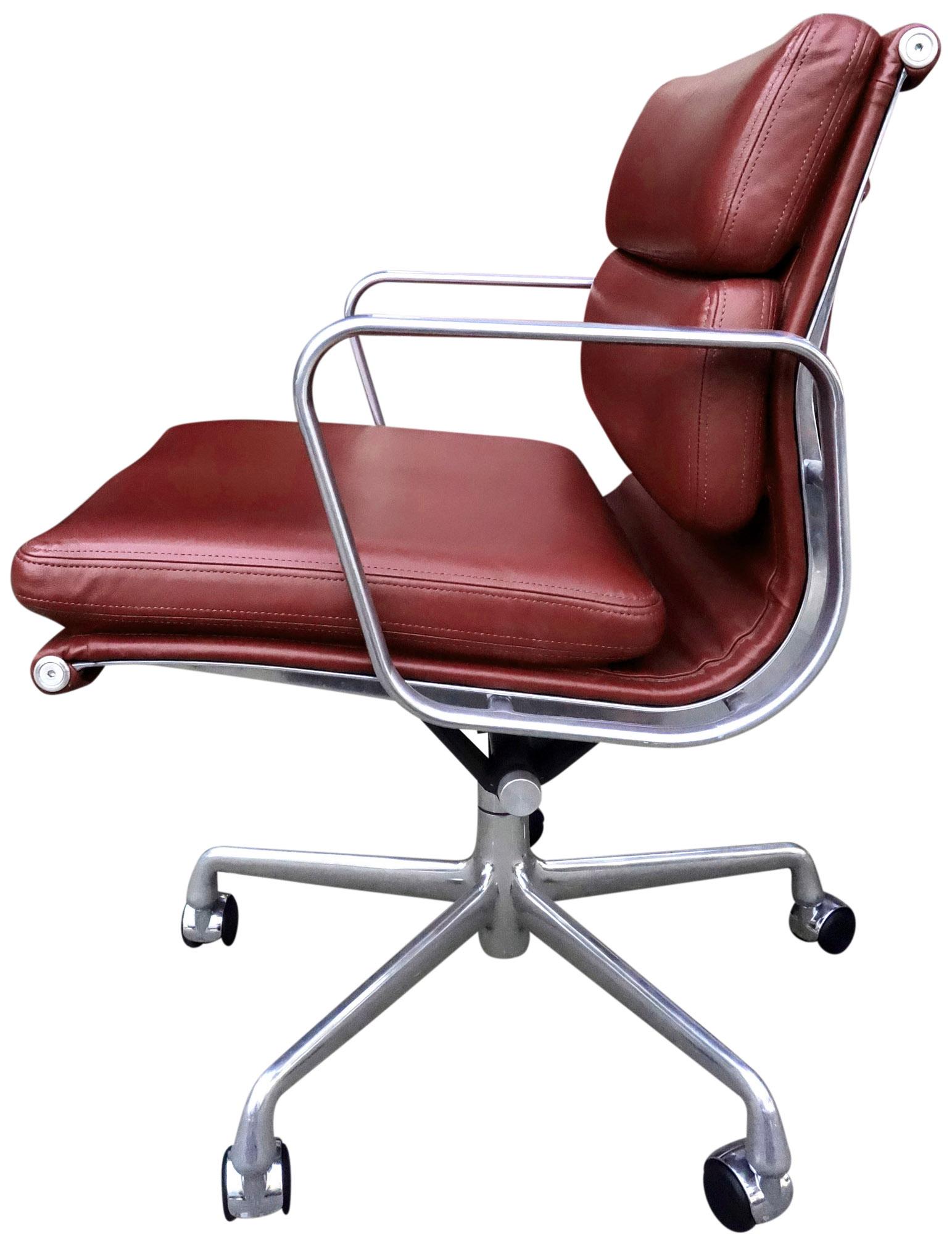 For your consideration are these authentic Eames for Herman Miller vintage soft pad chairs on 5 star base in ox blood red, burgundy leather. Adjustable tilt and height with manual lift. This authentic vintage example are icons of Mid-Century Modern