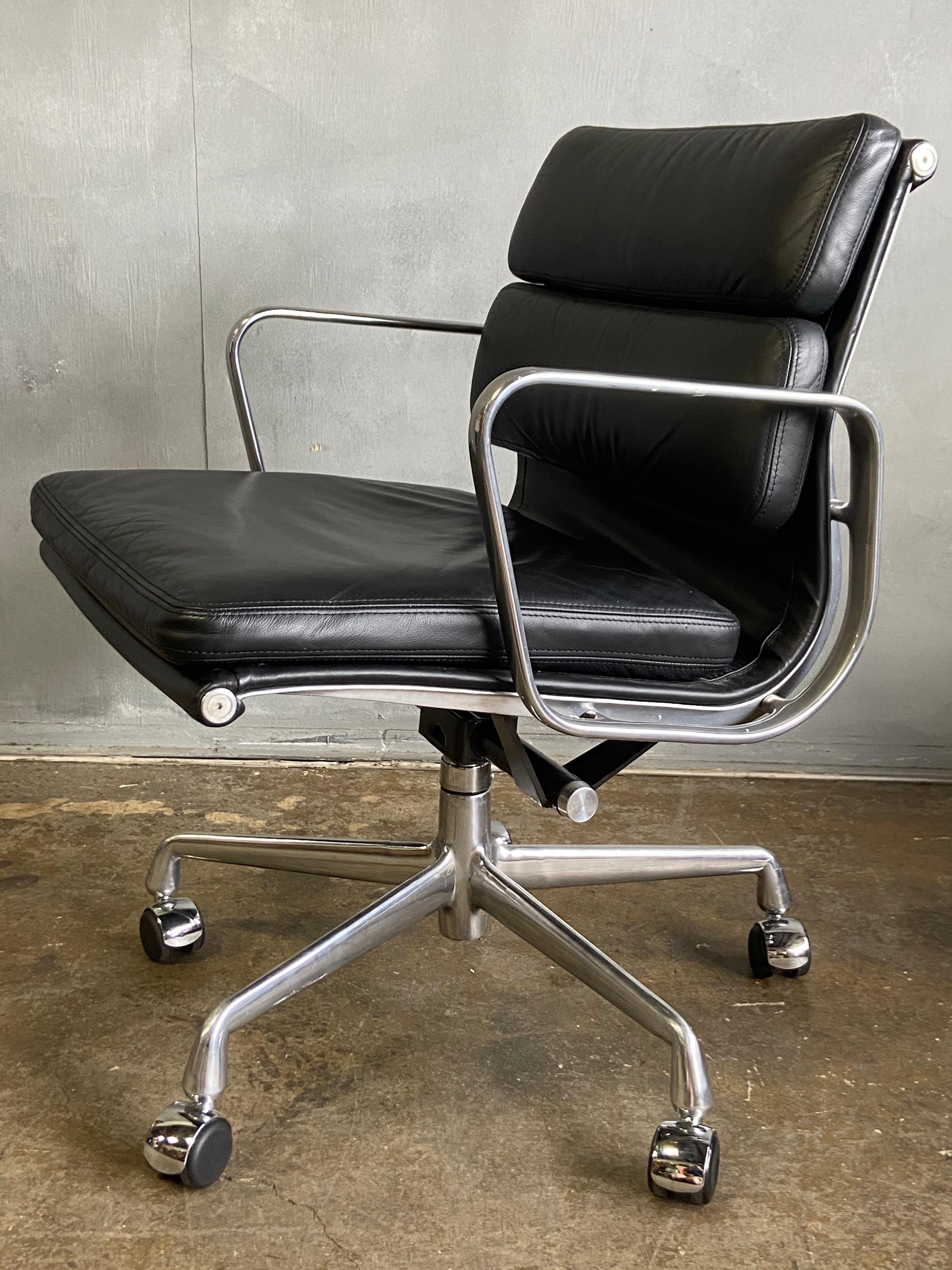  Eames for Herman Miller Soft Pad chairs in black leather with low backs. 

These authentic vintage examples are icons of Mid-Century Modern design. The chairs part of the Eames aluminium group designed for Herman Miller revolutionized office