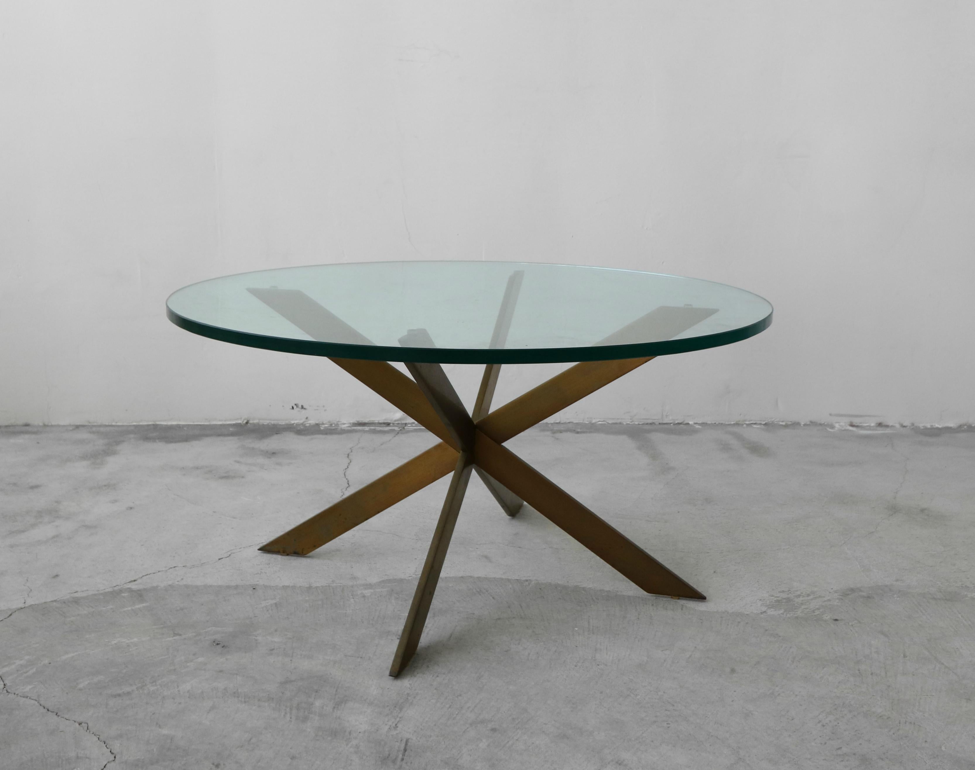 A beautiful solid bronze coffee table by Leon Rosen for base. Such a simple, yet modern and elegant piece. Base is solid bronze, weighing at least 40lbs.

Bronze has the most beautiful patina. Left as found, could be polished to bring it back to