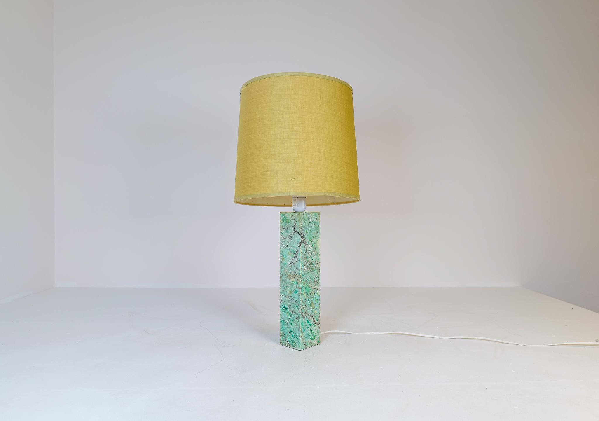 This marble table lamp was produced by Bergboms lamp factory in Sweden. This one with a rare green marble with exceptional grain. Original green / olive shade. 

Good vintage condition, one side with small marks and the shade with some stains. New