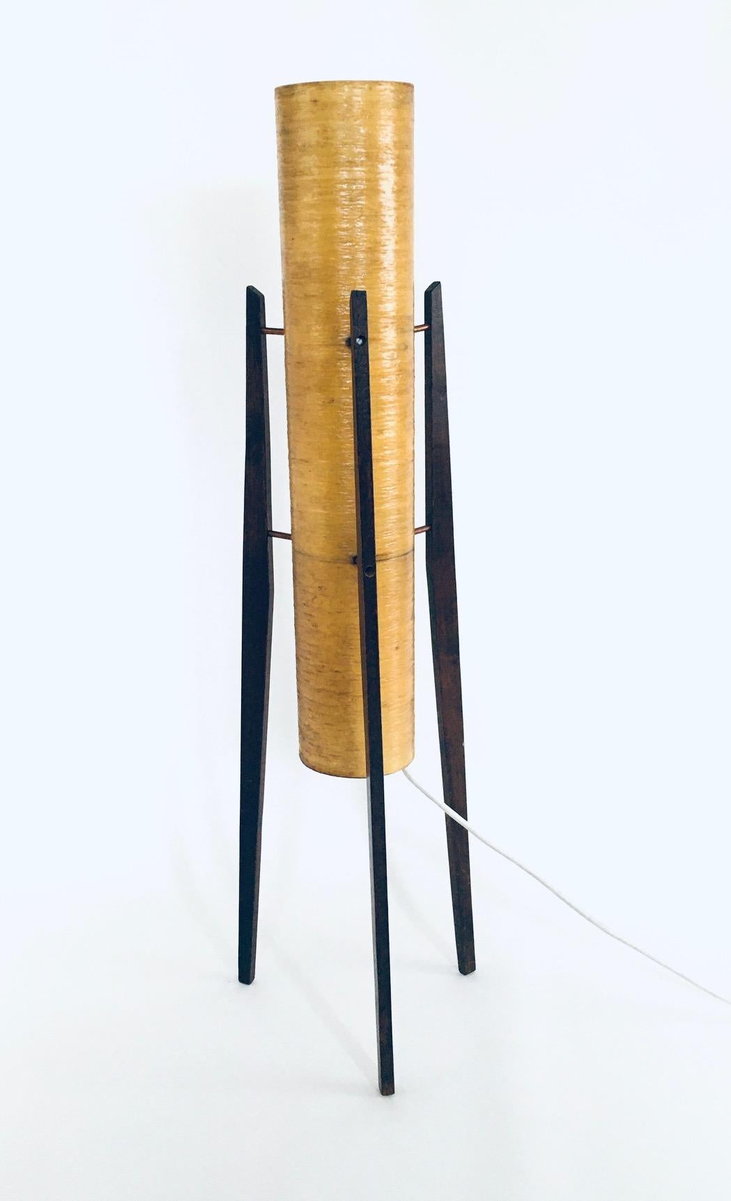 Vintage midcentury Space Age Design ROCKET floor lamp by Novoplast. Made in Czechoslovakia, 1950's / 60's. Yellow fiber plastic shade with wooden tripod legs. Original condition with new wire and plug. Normal wear to the fiberplastic where the shade