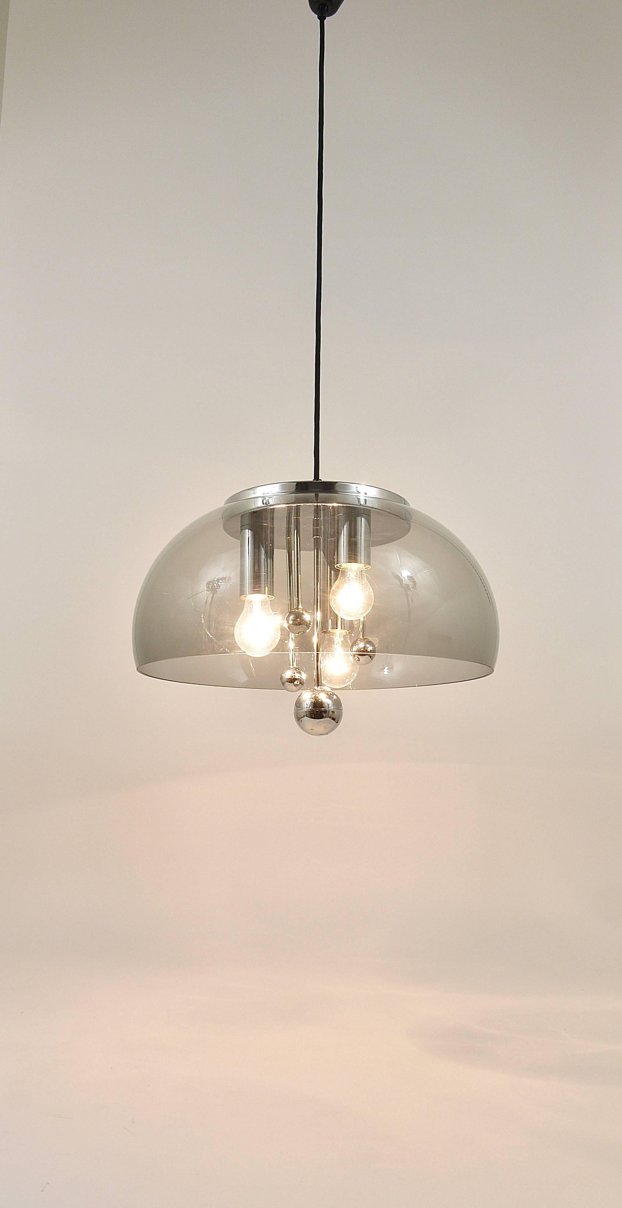 A beautiful completely chrome-plated ceiling light with a large light-grey smoked acrylic hemisphere lampshade and nice chromed ornamental globes inside. Made in Germany in the 1970s. Has three light sources and is in very condition with very