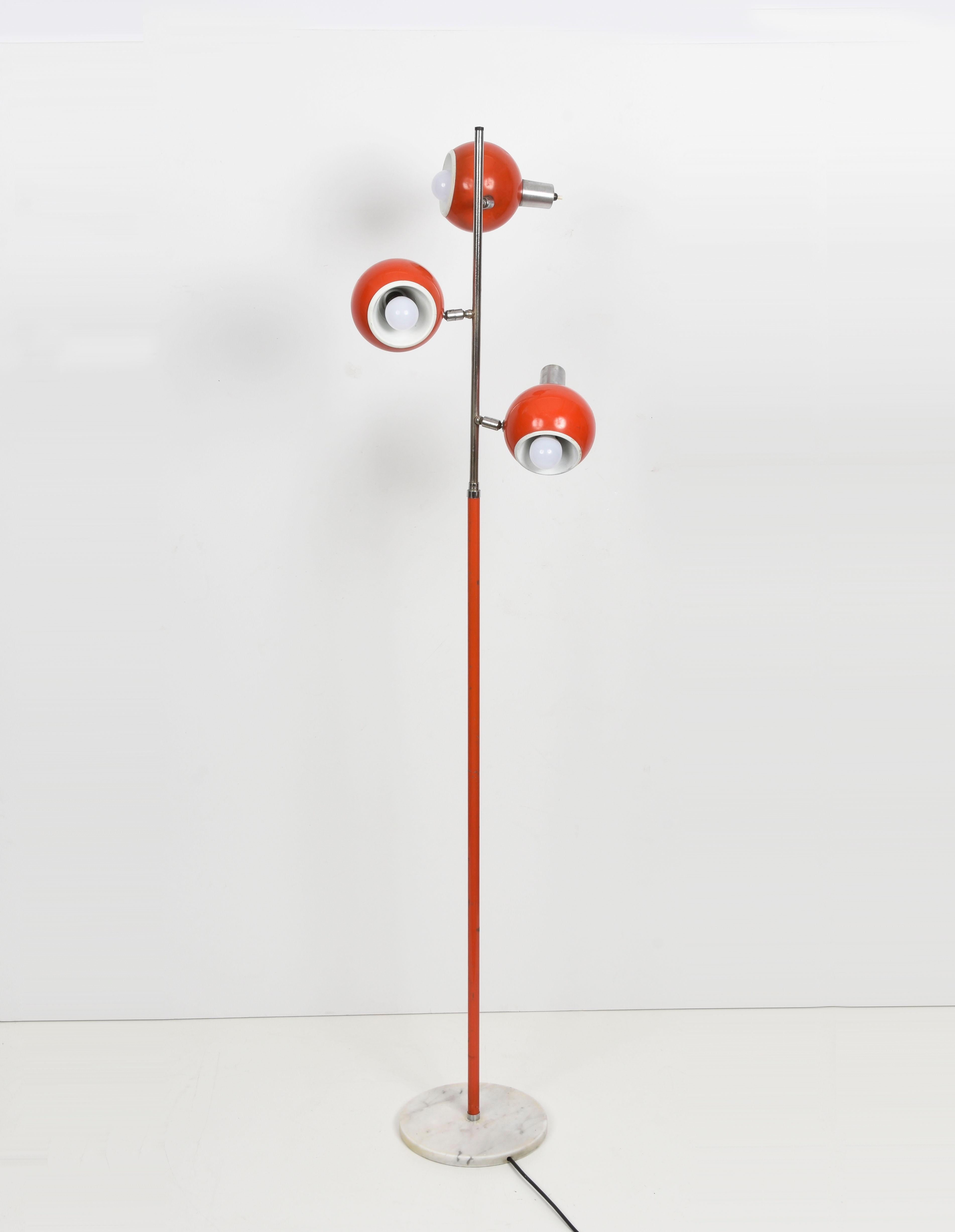 Amazing Space Age orange floor lamp with three adjustable lights and independent switching. This wonderful piece was designed in Italy during the 1970s and produced by Luci Italia manufacture.
 
This item has a base in Carrara white marble, three