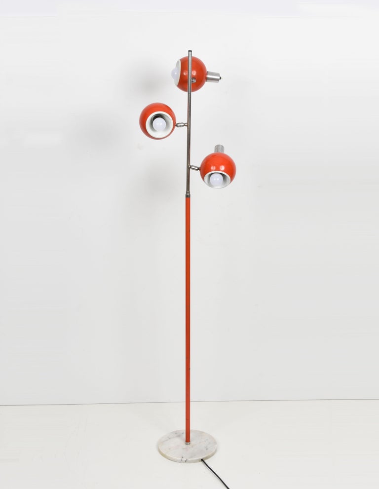 Amazing Space Age orange floor lamp with three adjustable lights and independent switching. This wonderful piece was designed in Italy during the 1970s and produced by Luci Italia manufacture.
 
This item has a base in Carrara white marble, three