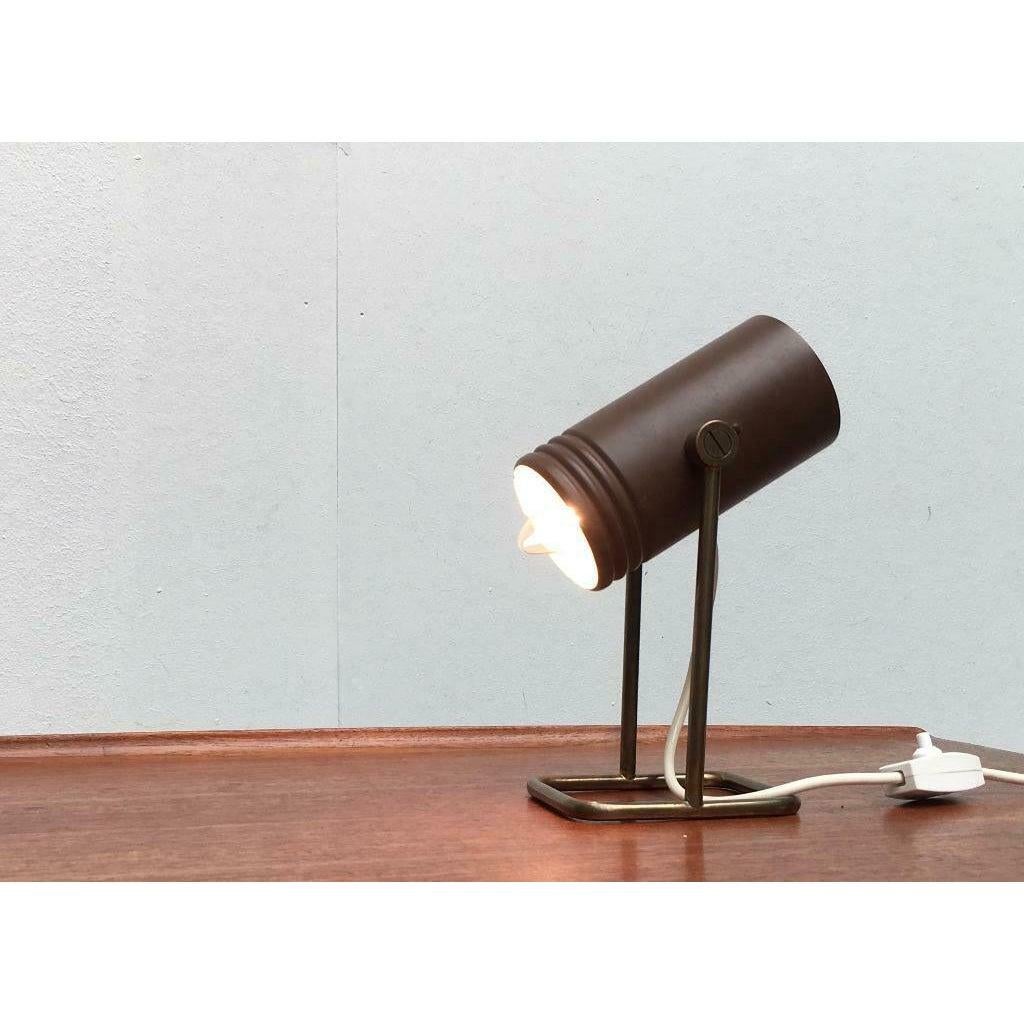 Rare mid-century table lamp by Heinz Neuhaus Leuchten, Germany based on a design by Rolf Krüger. Small table lamp with a very functional shape. A cylinder that is open on one side sits rotatably in a simple frame. The lamp is in good condition with