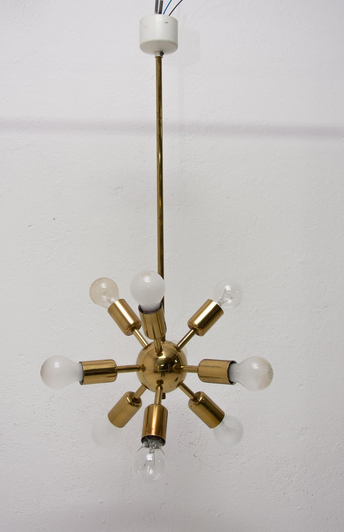 This Space Age Sputnik chandelier was made in the former Czechoslovakia in the 1960s by Drupol company. It features 10 brass arms with E27 bulb socket. The chandelier is in very good vintage condition just bears a minor signs of age and using. It