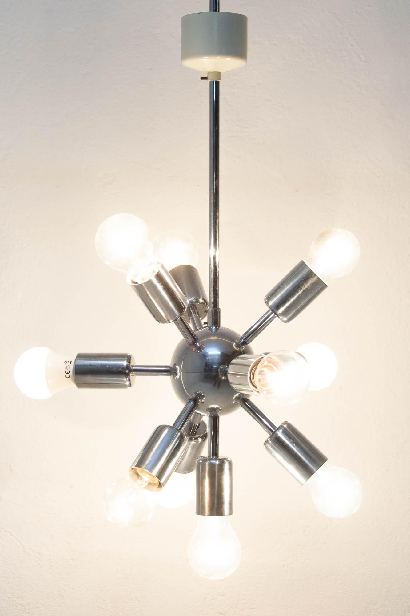 This Space Age Sputnik chandelier was made in the former Czechoslovakia by Drupol company in the 1960s. It features 10 chromed arms with E27 bulb socket. The chandelier is in very good vintage condition just bears a minor signs of age and using. It