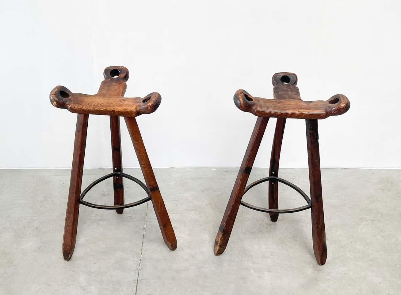 Rustic pair of famous Spanish bar chairs. These chairs are from the 7's. They show the typical T-shaped seat. 
The chairs are very practical and sturdy. 
 
They are in overall good condition and show signs of age according to age. 
