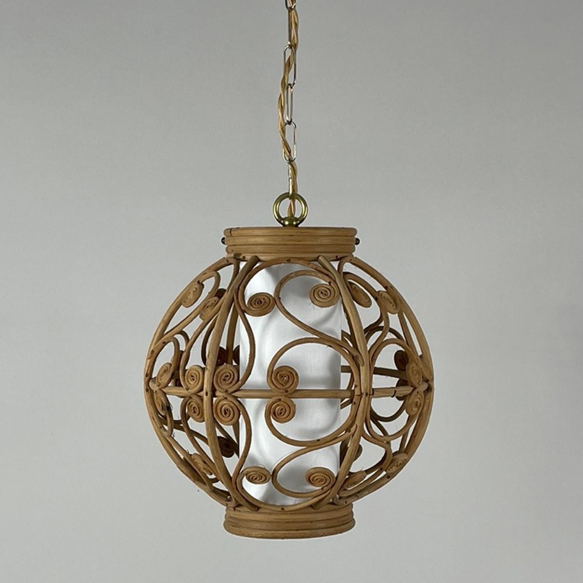 This beautiful handcrafted pendant was designed and manufactured in Spain in the 1950s to 1960s. It features a rattan lampshade with brass chain, silk cord and an off-white linen covered diffuser. Brass canopy.

The light has been rewired with new