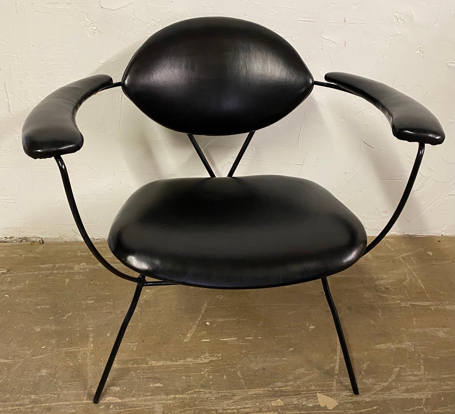 A fine Mid-Century Modern armchair, elegant and compact, standing on fine black iron spider legs. This stylish chair gives great comfort and support. This chair has recently been professionally restored. Great office chair, side chair or occasional