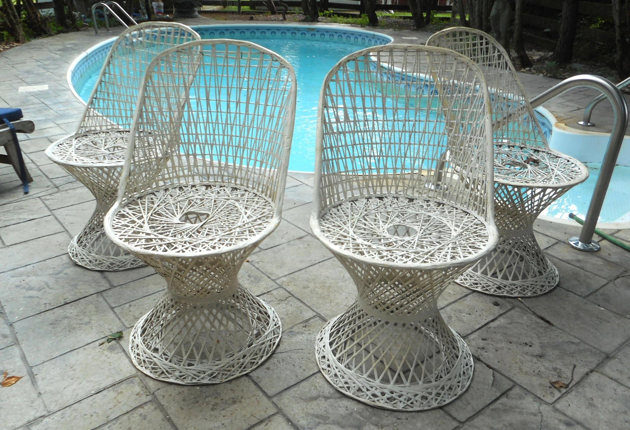 This beautiful vintage patio set includes a glass top table, four chairs, and three planters. The unique round glass top table features a tulip shaped spun fiberglass base. The stunning set of four sculpted patio chairs and three tulip shaped