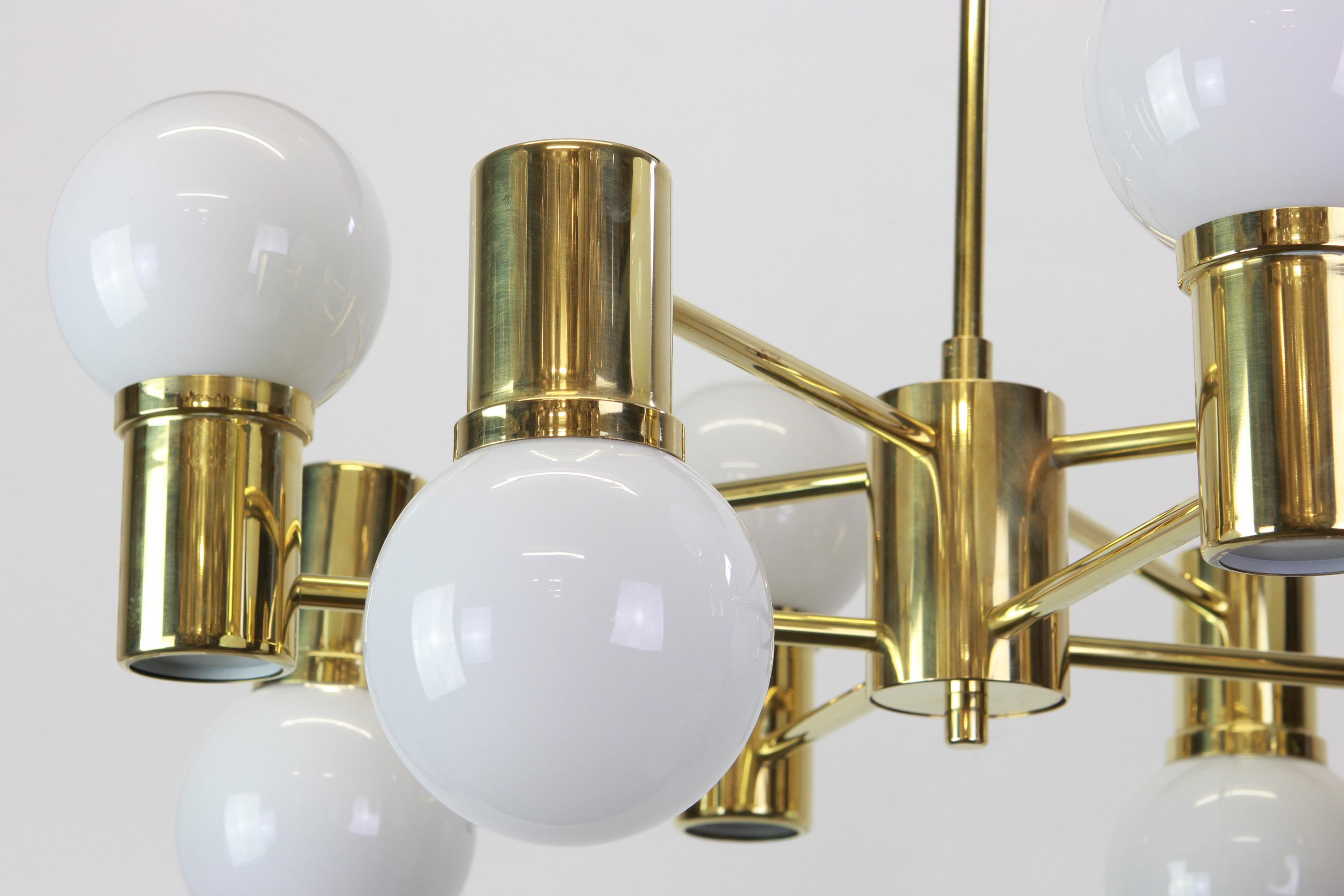 Stunning glass ceiling fixture with eight white opal glass globes on a brass frame.
Made by Doria -
Best of the 1960s from Germany.

High quality and in very good condition. Cleaned, well-wired and ready to use. 

The fixture requires 8 x E14