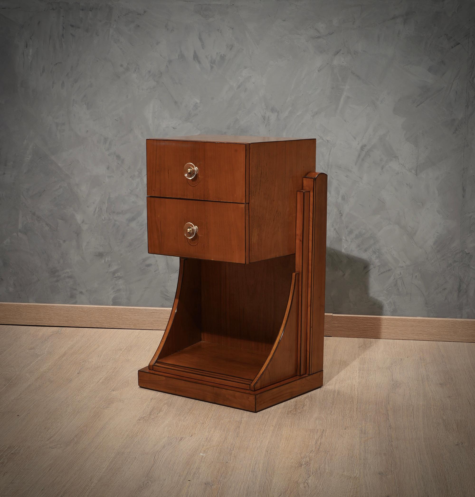 Unique and original piece of its kind, well articulated in its shape, wonderful patina and very warm color.

The bedside table consists of a square upper part that contains two drawers, which can be opened with two beautiful Murano glass handles.