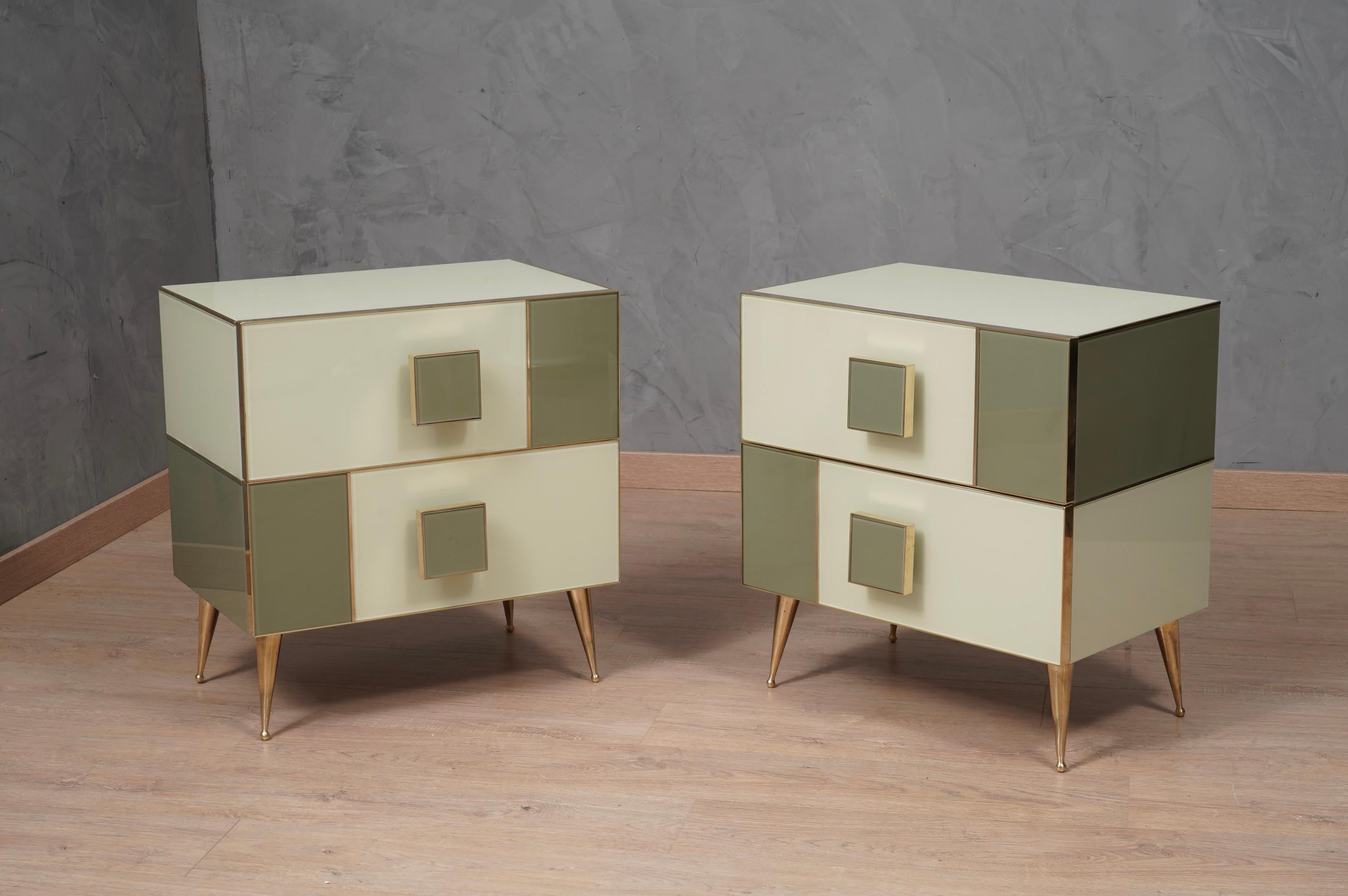 Classic design for a pair of night tables all in dove gray and cream colored glass and brass. Square and linear as in the style of that design.

The bedside tables have a wooden structure, above they have been covered with dove gray and cream
