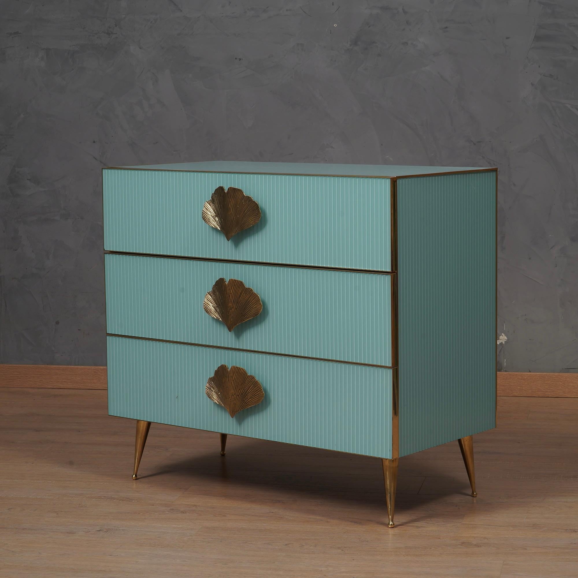 An unmistakable piece of furniture due to its light blue color, it exemplifies timeless design and exceptional craftsmanship. With the unique characteristics of fluted glass and meticulous attention to detail, this chest of drawers testifies to a