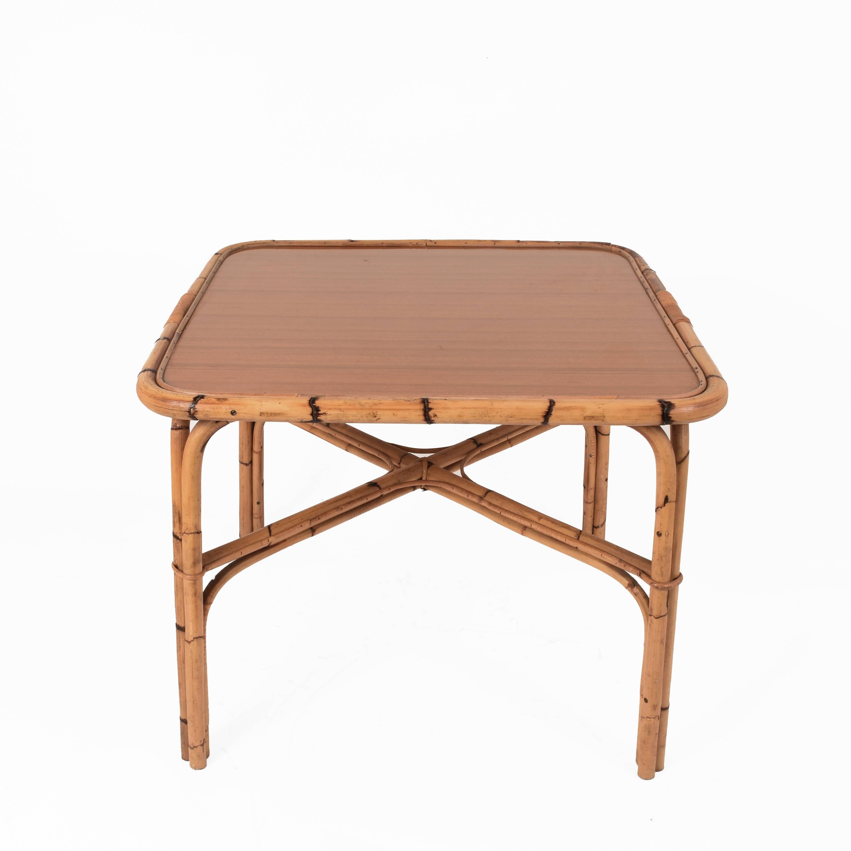 Wonderful midcentury squared bamboo table with Formica Laminated Top. The item was produced during the 1960s in Italy.

The item is made of a clean laminated formica top sustained on the sides by bamboo canes, which compose the structure of the