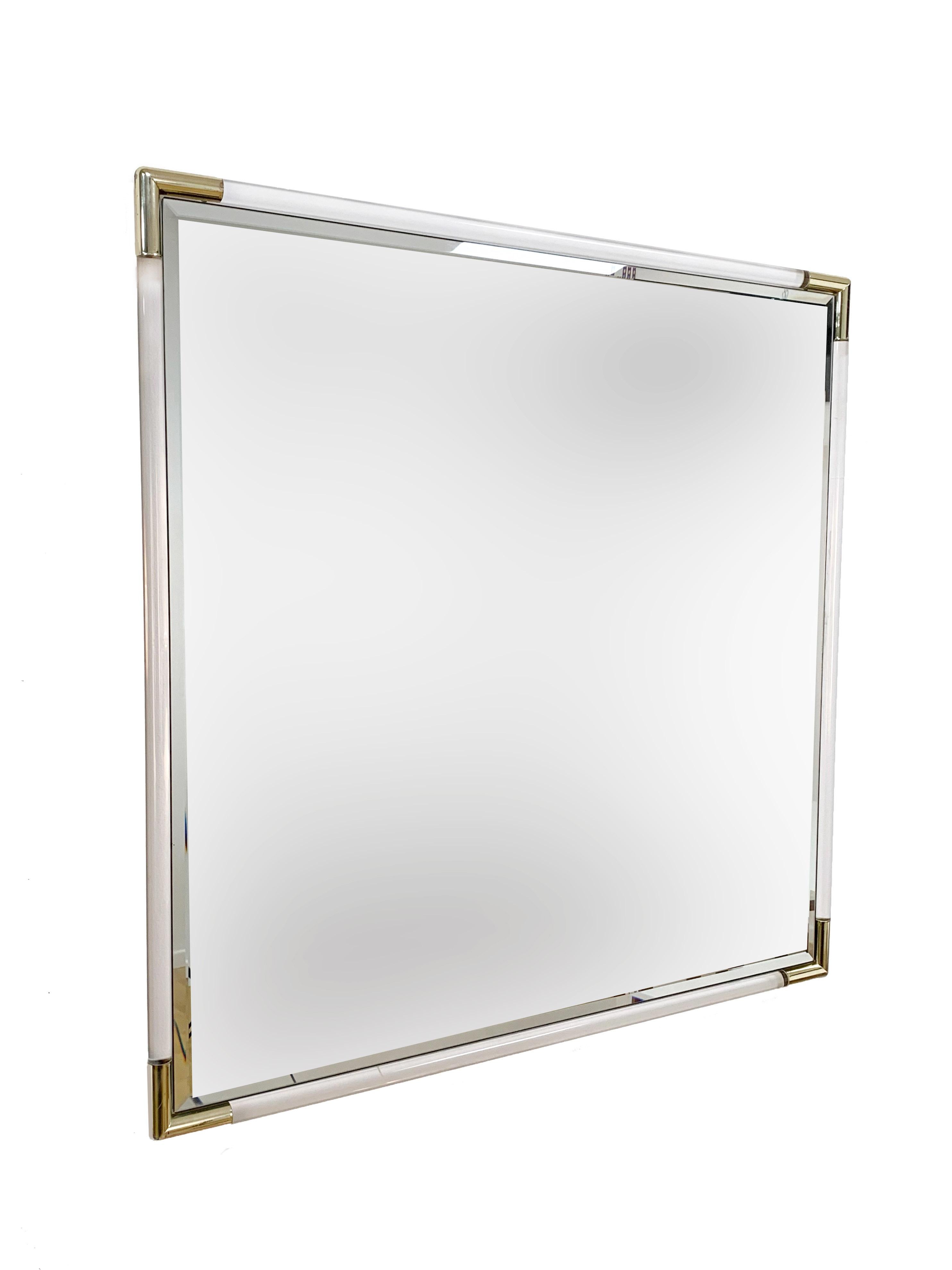 Amazing finely carved wall mirror with Lucite frame and corners in gilded metal. 

This squared mirror was produced in Italy during the 1970s.

An elegant piece that, with its midcentury lines, will enrich a modern living room.

Measures