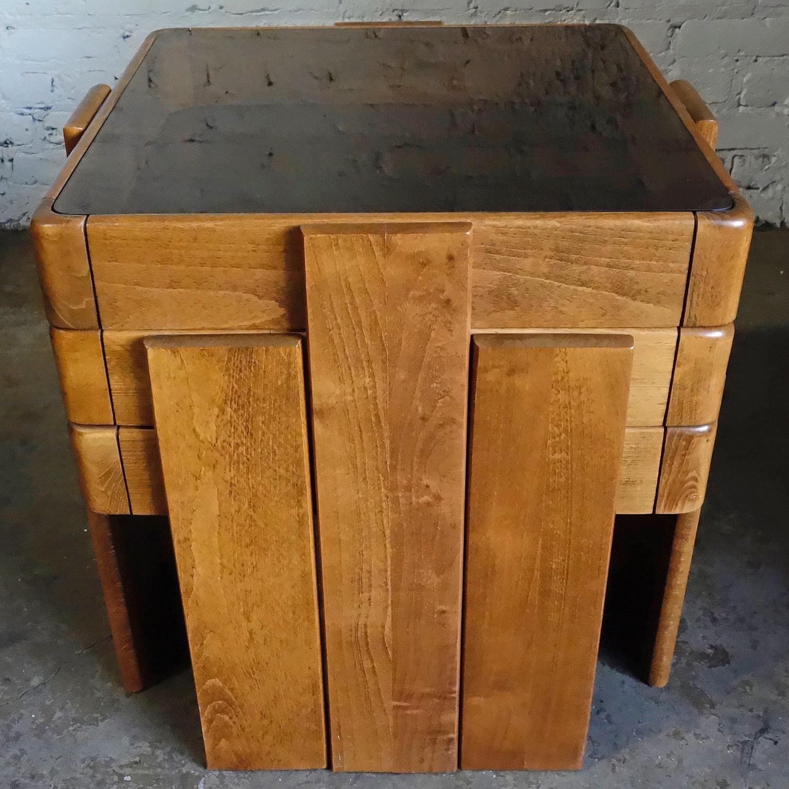 Versatile and stylish nesting tables with a wood frame and inset smoked glass. I have seen these used as graduating coffee tables, side tables, and end tables. 

Largest table is 20' cubed.