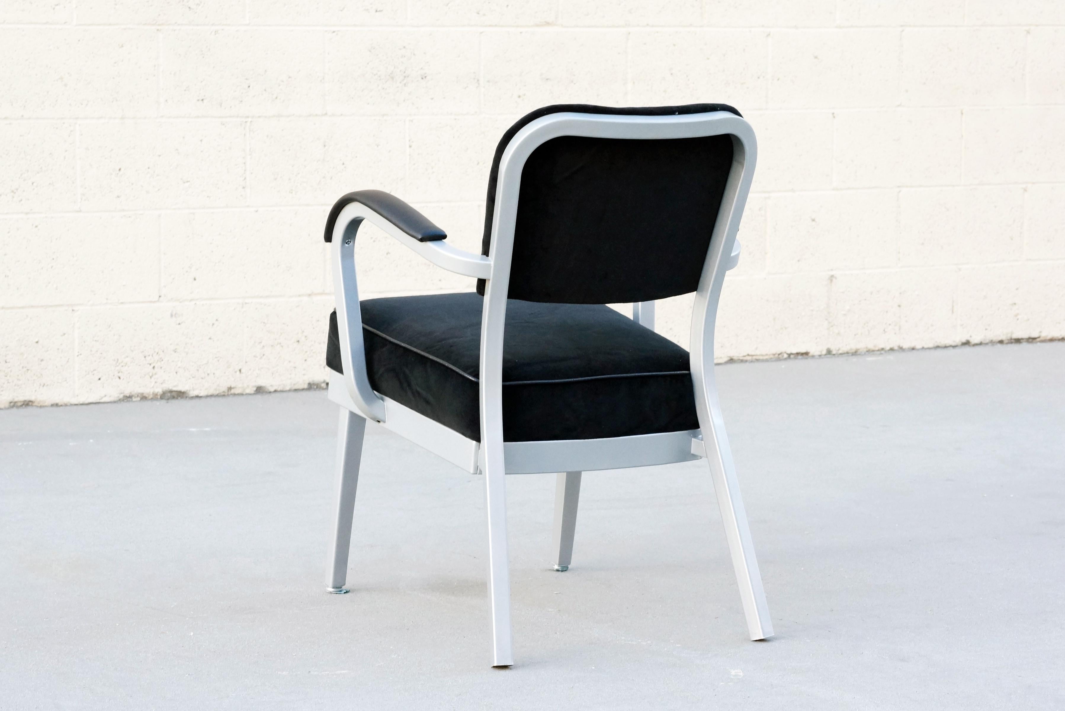 Classic mid century steel tanker armchair refinished in metallic silver powder-coated frame and reupholstered in black velvet with black vinyl armcaps. 

Dimensions: 24