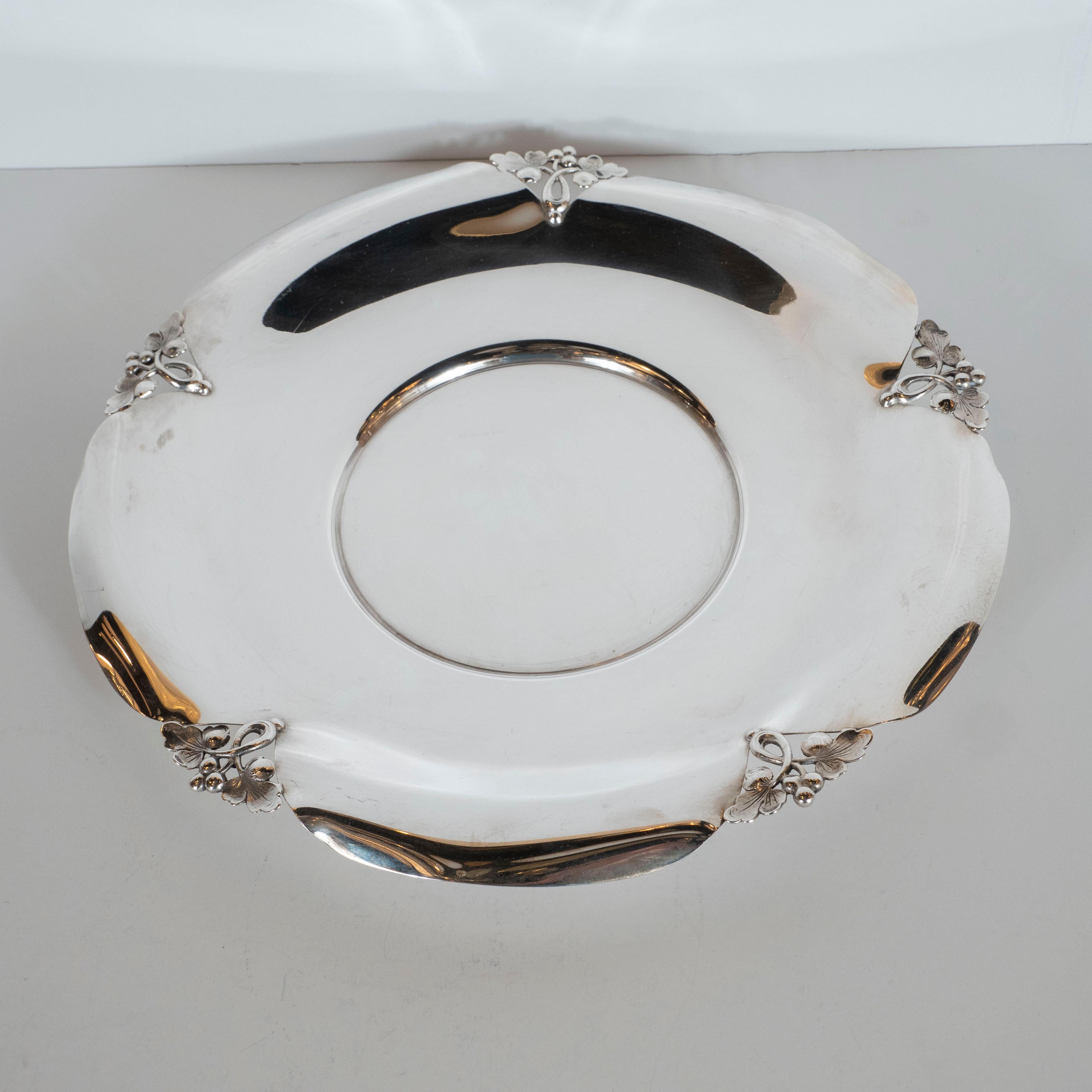 This stunning Art Deco decorative tray was realized by the Philadelphia based fabled American jeweler and producer of fine luxury silver goods, James Emmot Caldwell, since 1839. It features a circular body with concentric circular insets, fitted