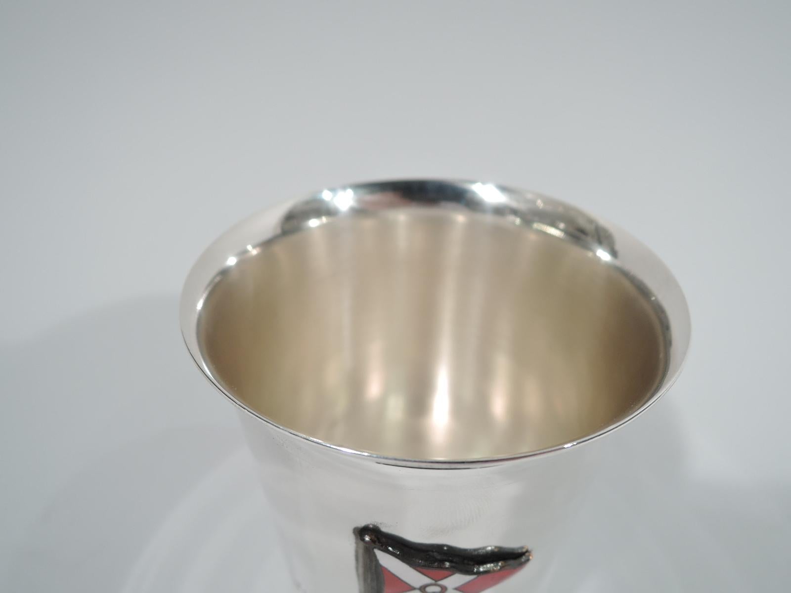 Mid-Century Modern sterling silver tumbler. Straight and tapering sides, and flared rim. On front is engraved “1957 / Wednesday July Series / Winner”. Above is applied red and white pennant with letter Q. Marked “John Frick / Jlry. Co. N.Y. /