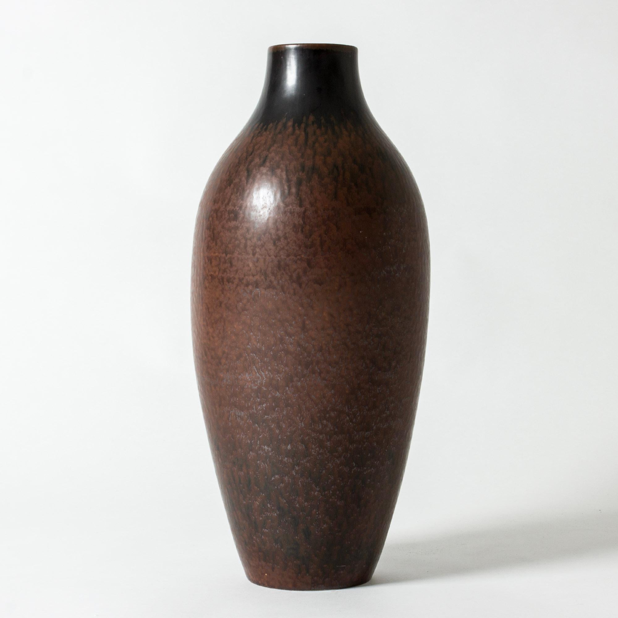 Statuesque stoneware floor vase by Carl-Harry Stålhane, in a clean form with rich brown glaze with grey streaks.

Carl-Harry Stålhane was one of the stars among Swedish ceramic artists during the 1950s, 1960s and 1970s, whose designs are just as