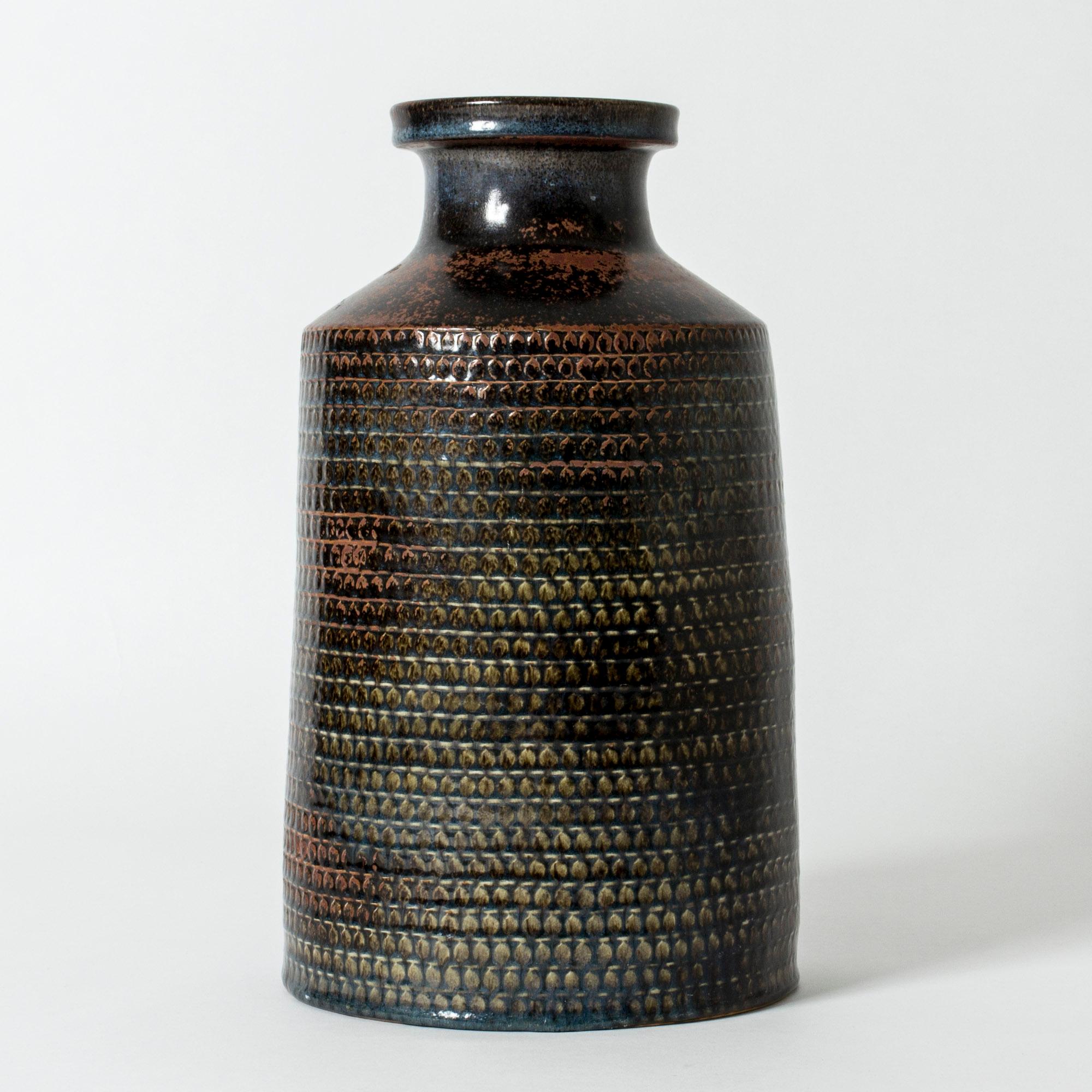 Unique stoneware floor vase by Stig Lindberg, in a clean design with a graphic patterned surface with structure. Glaze in dark natural colors ranging from rust to steely blue.