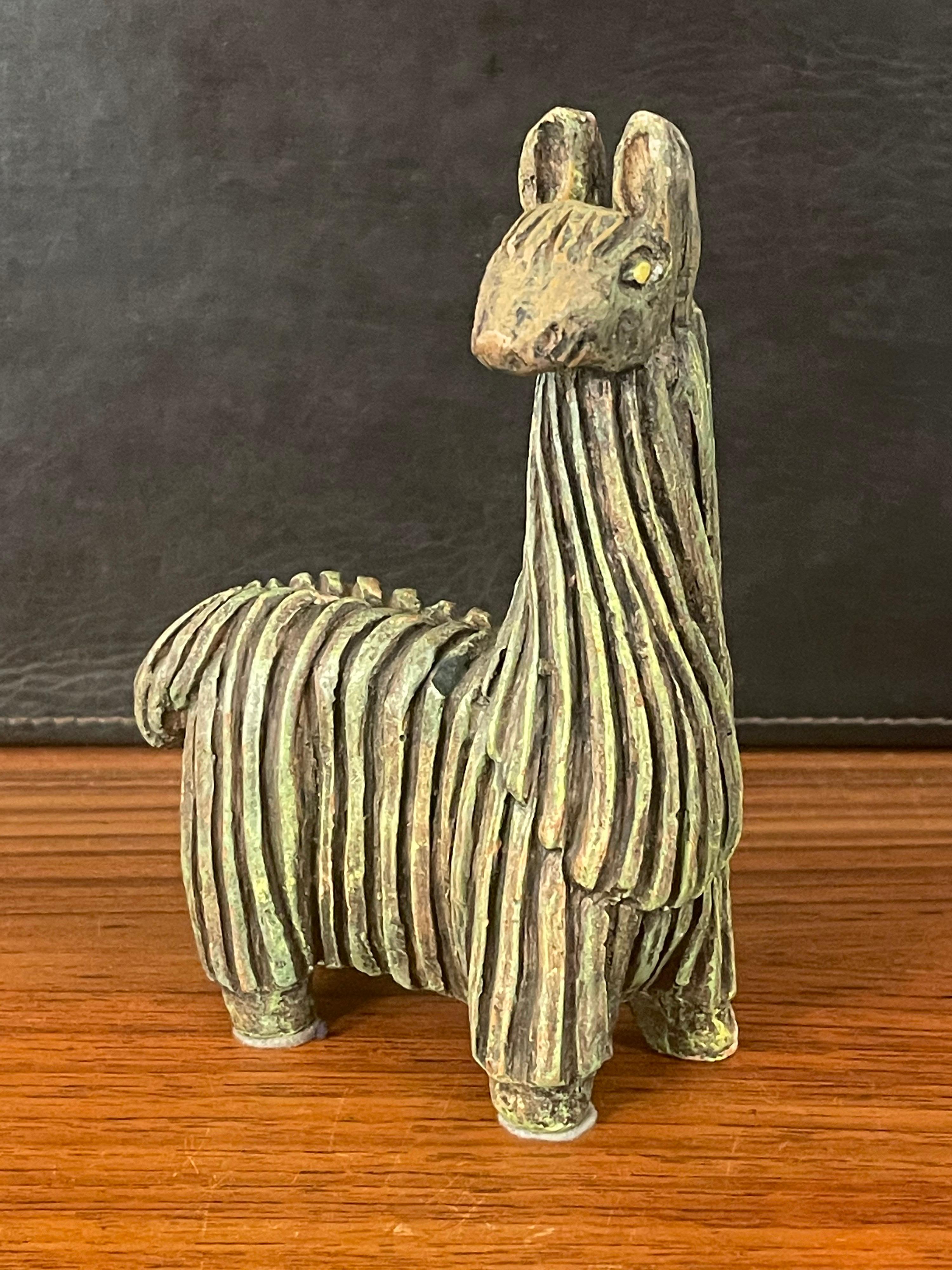 A very cool mid-century stoneware llama by Fabbri Art Co. of San Francisco, circa 1970s. The llama has been beautifully sculpted with deep striking texture in a rich deep greenish color.

The piece stands 7.5