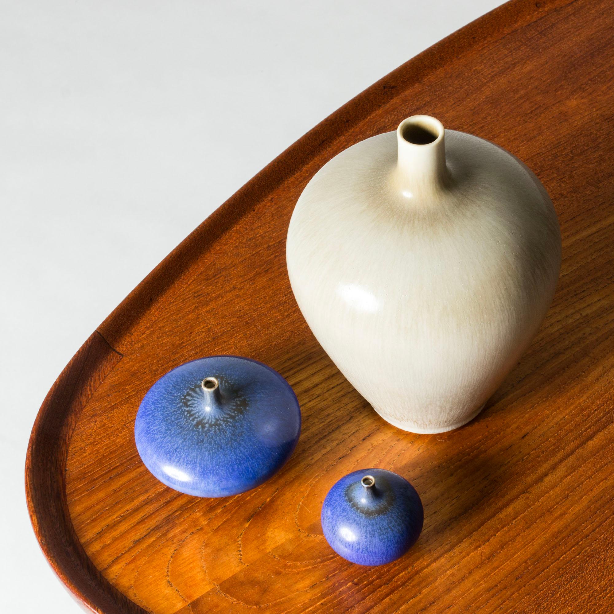 Perfect miniature stoneware vase by Berndt Friberg, in a smooth drop form with a thin neck. Bright blue hare’s fur glaze with a darker ring close to the neck.

Berndt Friberg was a Swedish ceramicist, renowned for his stoneware vases and vessels for