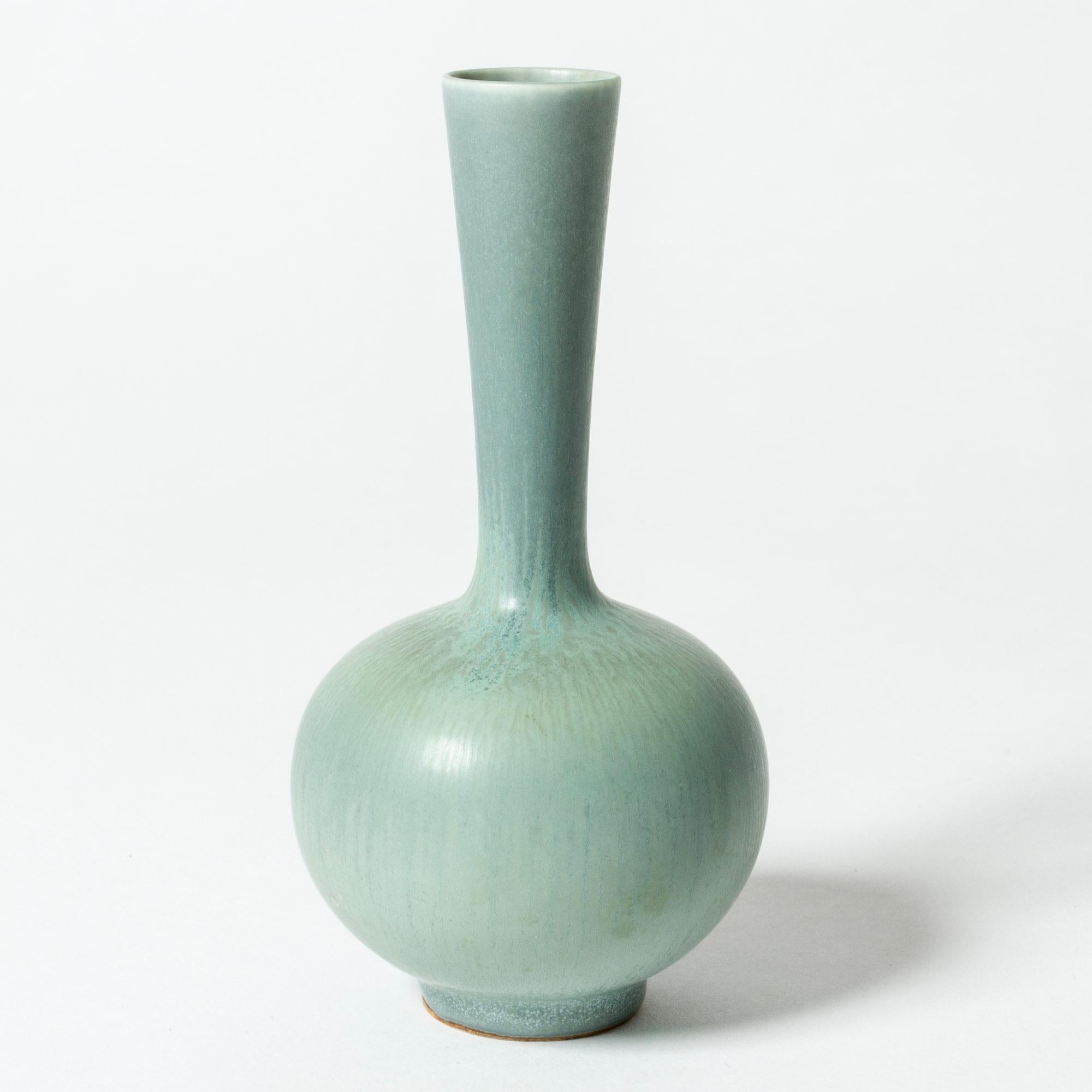 Stoneware vase by Berndt Friberg, in a neat onion shaped form. Beautiful ocean blueish hare’s fur glaze.

Berndt Friberg was a Swedish ceramicist, renowned for his stoneware vases and vessels for Gustavsberg. His pure, composed designs with