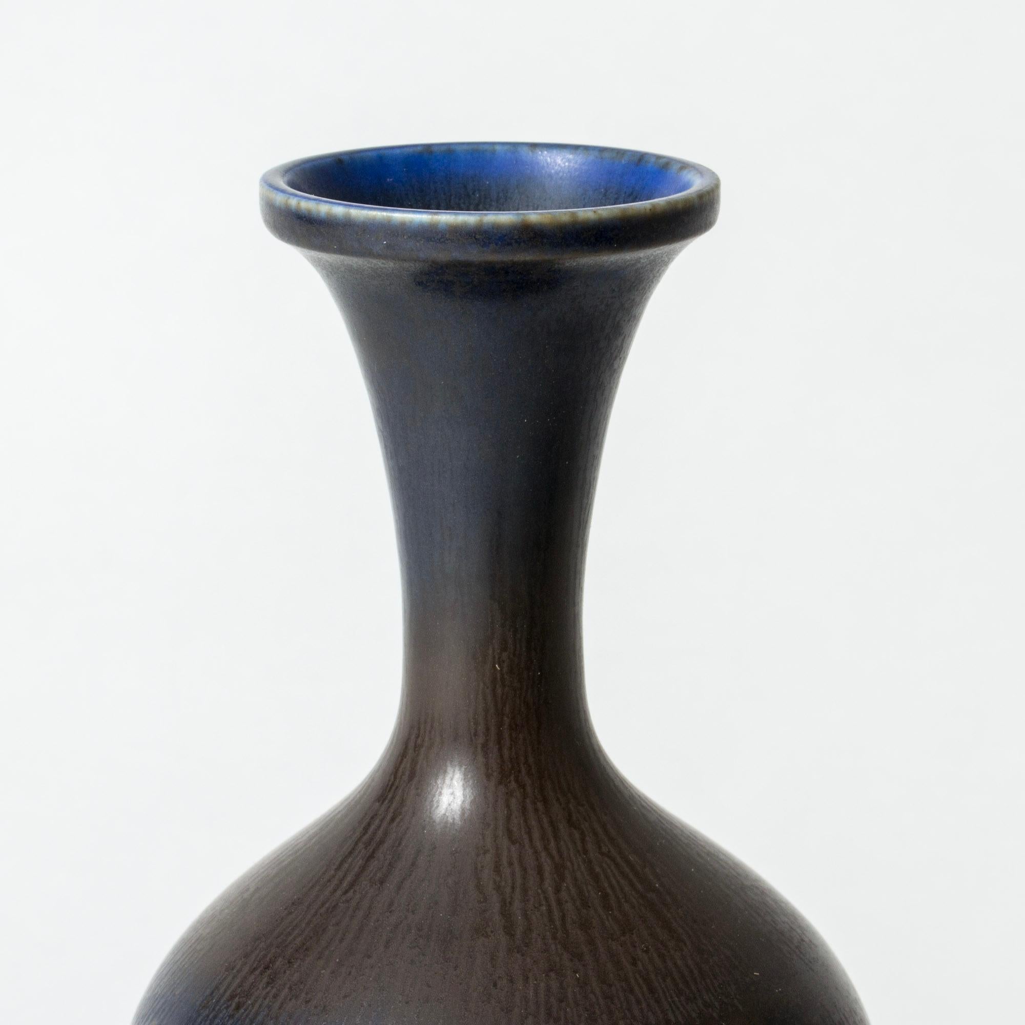 Stoneware vase by Berndt Friberg, in an elegant sleek form. Beautiful dark blue hare’s fur glaze.

Berndt Friberg was a Swedish ceramicist, renowned for his stoneware vases and vessels for Gustavsberg. His pure, composed designs with satiny,