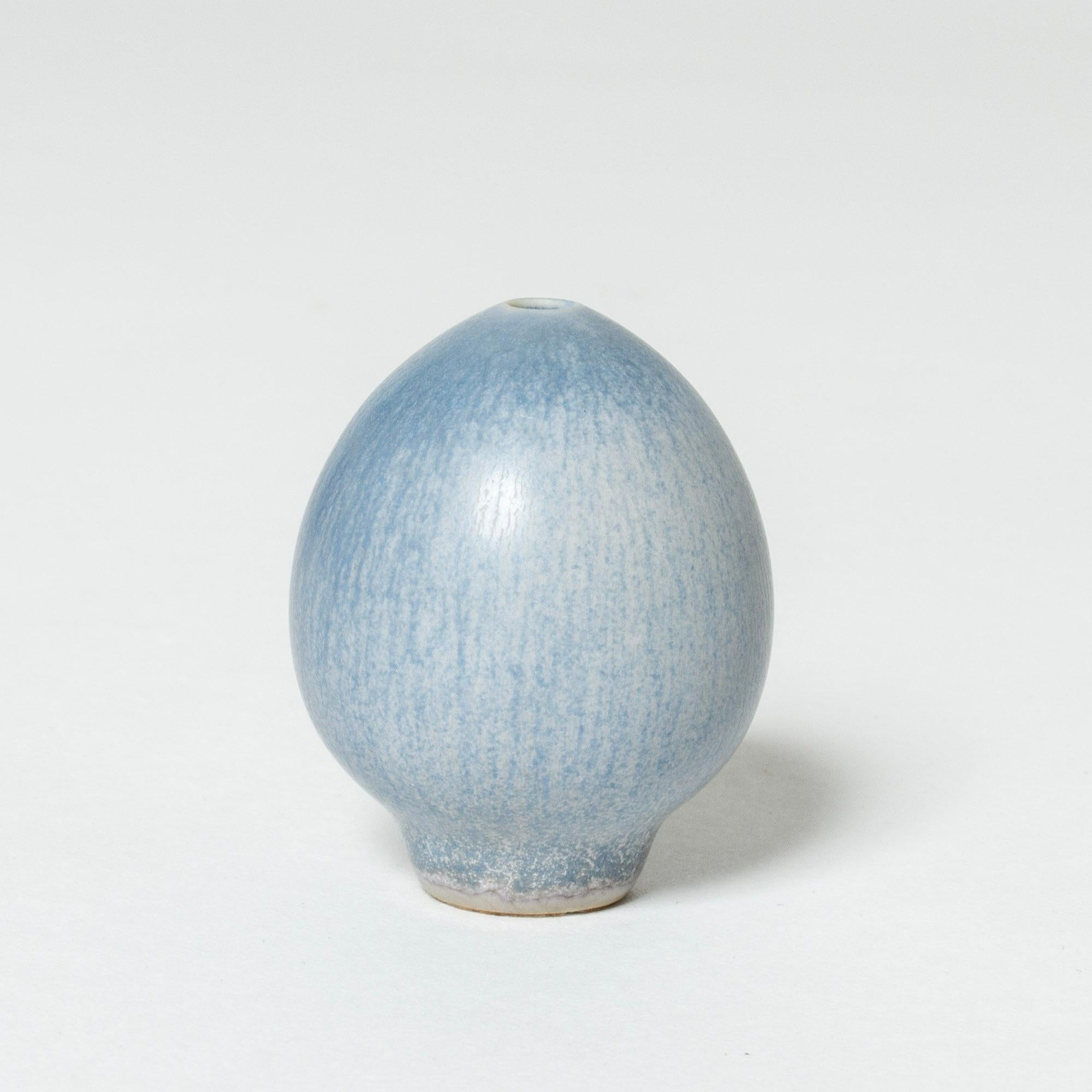 Tiny stoneware vase by Berndt Friberg, in the form of an egg. Smooth, icy blue hare’s fur glaze.

Berndt Friberg was a Swedish ceramicist, renowned for his stoneware vases and vessels for Gustavsberg. His pure, composed designs with satiny,