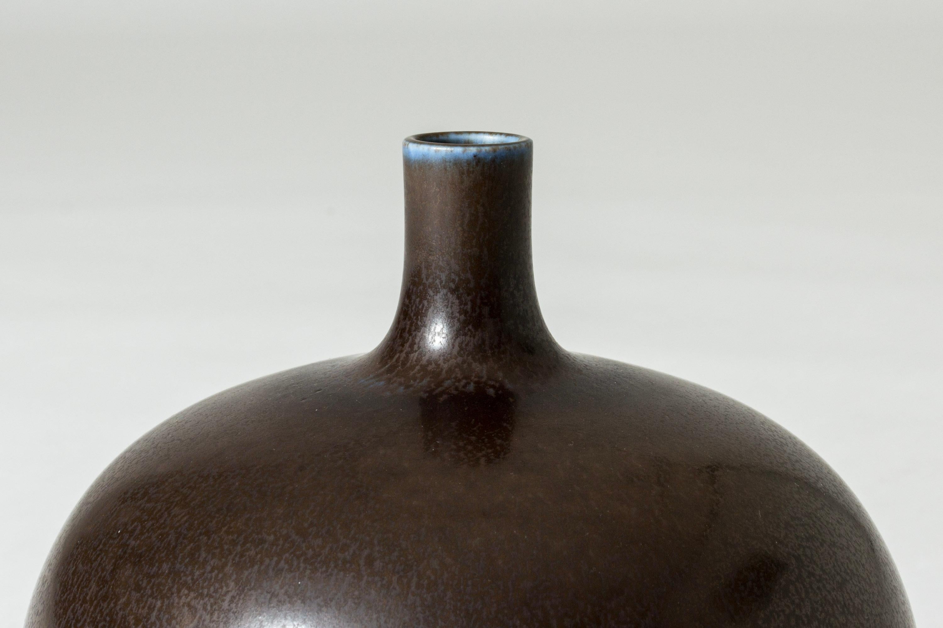 Beautiful stoneware vase by Berndt Friberg in an appealing, round form. Brown hare’s fur glaze with a streak of blue around the rim.

Berndt Friberg was a Swedish ceramicist, renowned for his stoneware vases and vessels for Gustavsberg. His pure,