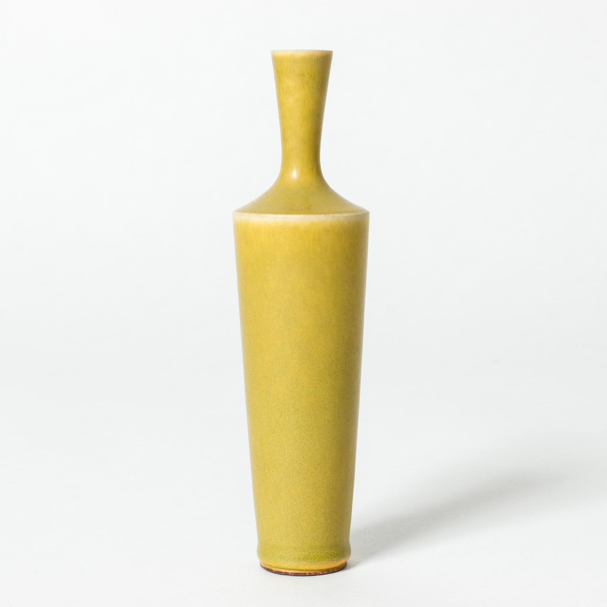 Stoneware vase by Berndt Friberg in an elegant, statuesque form. Intense yellow hare’s fur glaze.

Berndt Friberg was a Swedish ceramicist, renowned for his stoneware vases and vessels for Gustavsberg. His pure, composed designs with satiny,