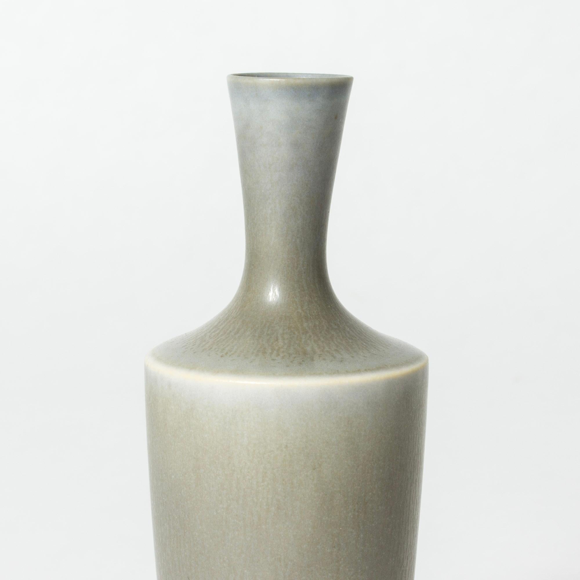 Stoneware vase by Berndt Friberg in an elegant, statuesque form. Pale blueish grey hare’s fur glaze.

Berndt Friberg was a Swedish ceramicist, renowned for his stoneware vases and vessels for Gustavsberg. His pure, composed designs with satiny,