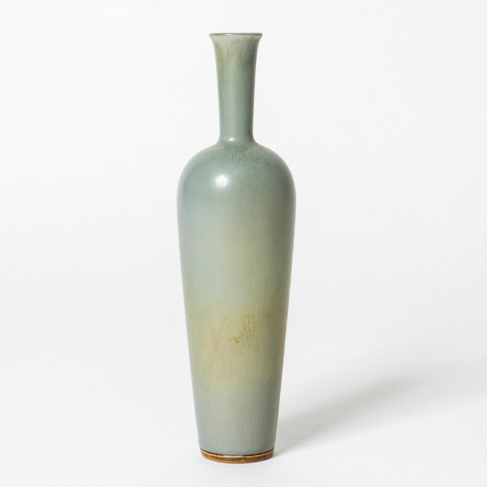 Stoneware vase by Berndt Friberg in an elegant form with pale celadon colored hare’s fur glaze and contrasting rusty nuances.

Berndt Friberg was a Swedish ceramicist, renowned for his stoneware vases and vessels for Gustavsberg. His pure, composed