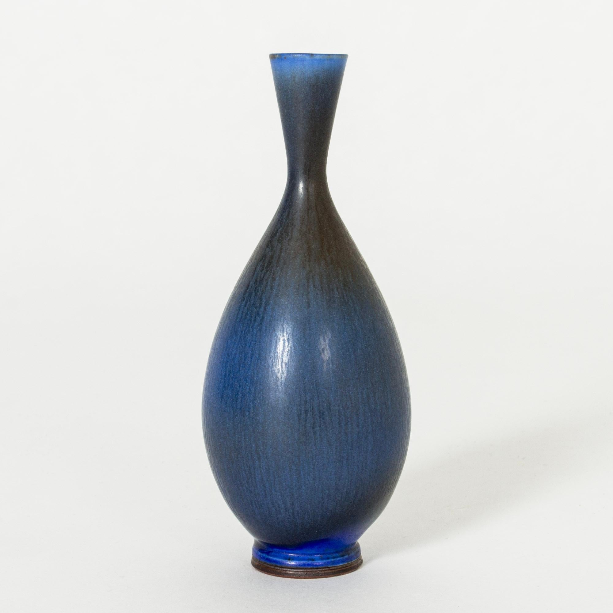 Beautiful, small stoneware vase by Berndt Friberg, in a curvesome form with blue hare’s fur glaze, blending into darker blue.

Berndt Friberg was a Swedish ceramicist, renowned for his stoneware vases and vessels for Gustavsberg. His pure, composed