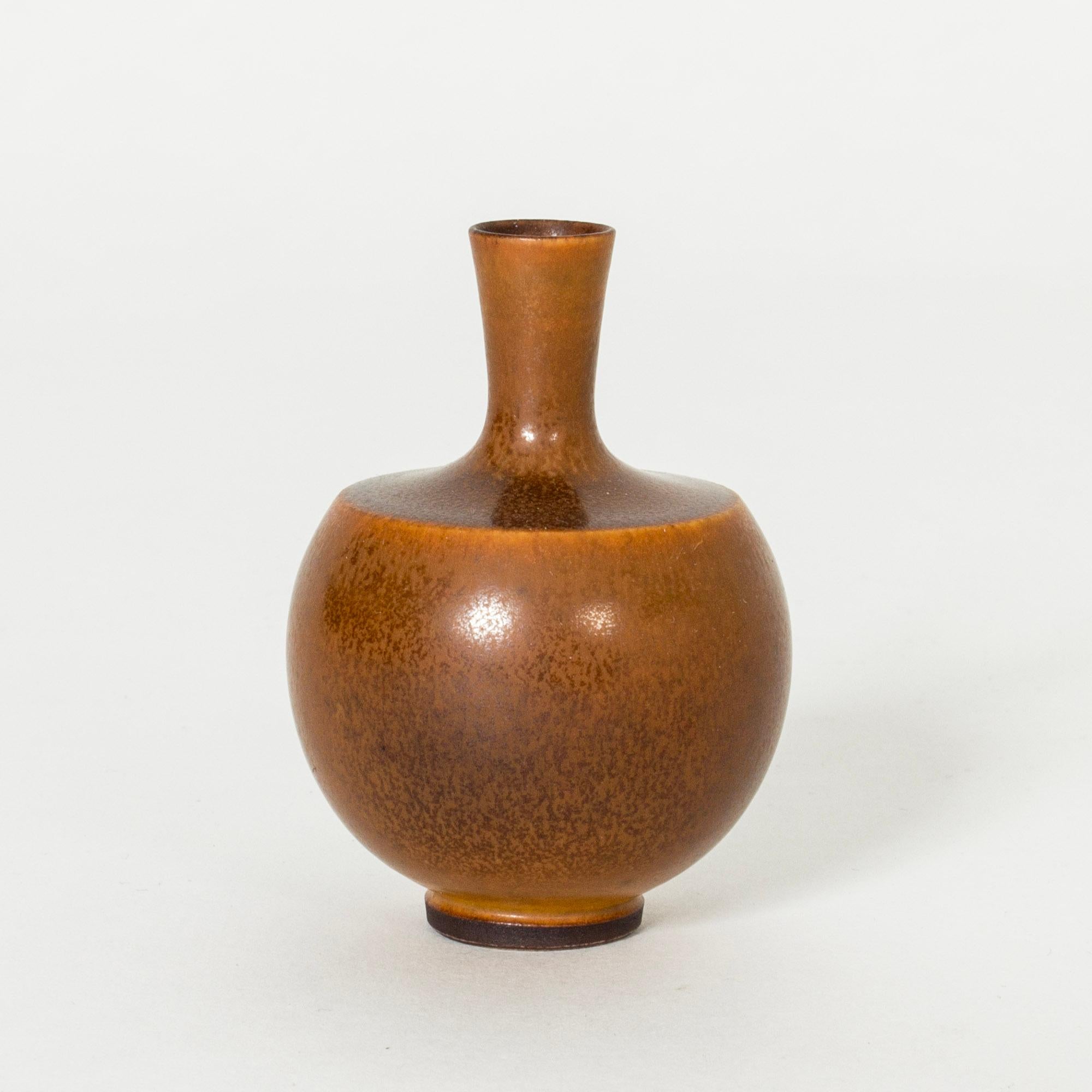 Lovely tiny stoneware vase by Berndt Friberg, in a compact form with rich brown hare’s fur glaze.

Berndt Friberg was a Swedish ceramicist, renowned for his stoneware vases and vessels for Gustavsberg. His pure, composed designs with satiny,