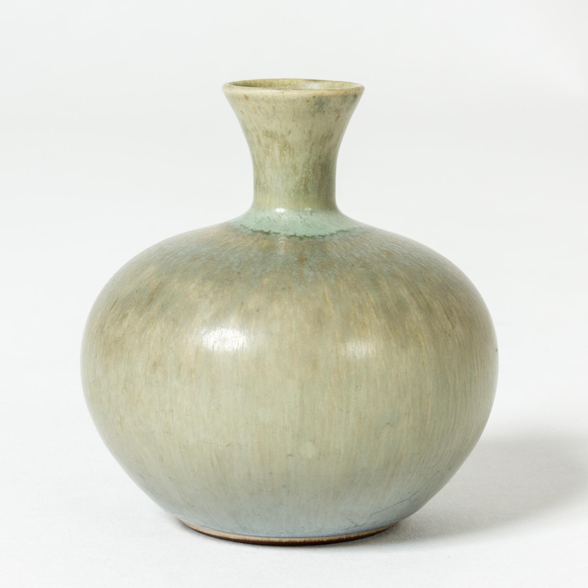 Small stoneware vase by Berndt Friberg, in a soft plump form with appealing celadon green hare’s fur glaze.

Berndt Friberg was a Swedish ceramicist, renowned for his stoneware vases and vessels for Gustavsberg. His pure, composed designs with