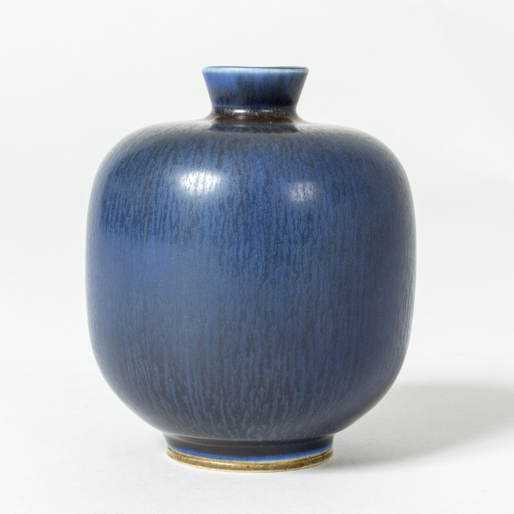 Small stoneware vase by Berndt Friberg, in a stout form with elegant blue hare’s fur glaze.

Berndt Friberg was a Swedish ceramicist, renowned for his stoneware vases and vessels for Gustavsberg. His pure, composed designs with satiny, compelling